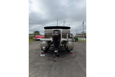 2022 SUNTRACKER Party Barge 22 pontoon boat on trailer, parked outdoors.