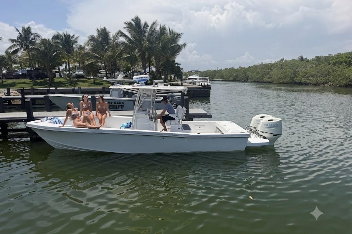 2025 Ocean Master 296 boat with passengers, docked near lush greenery and palm trees.