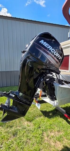 A Mercury outboard motor is attached to a boat on a trailer.