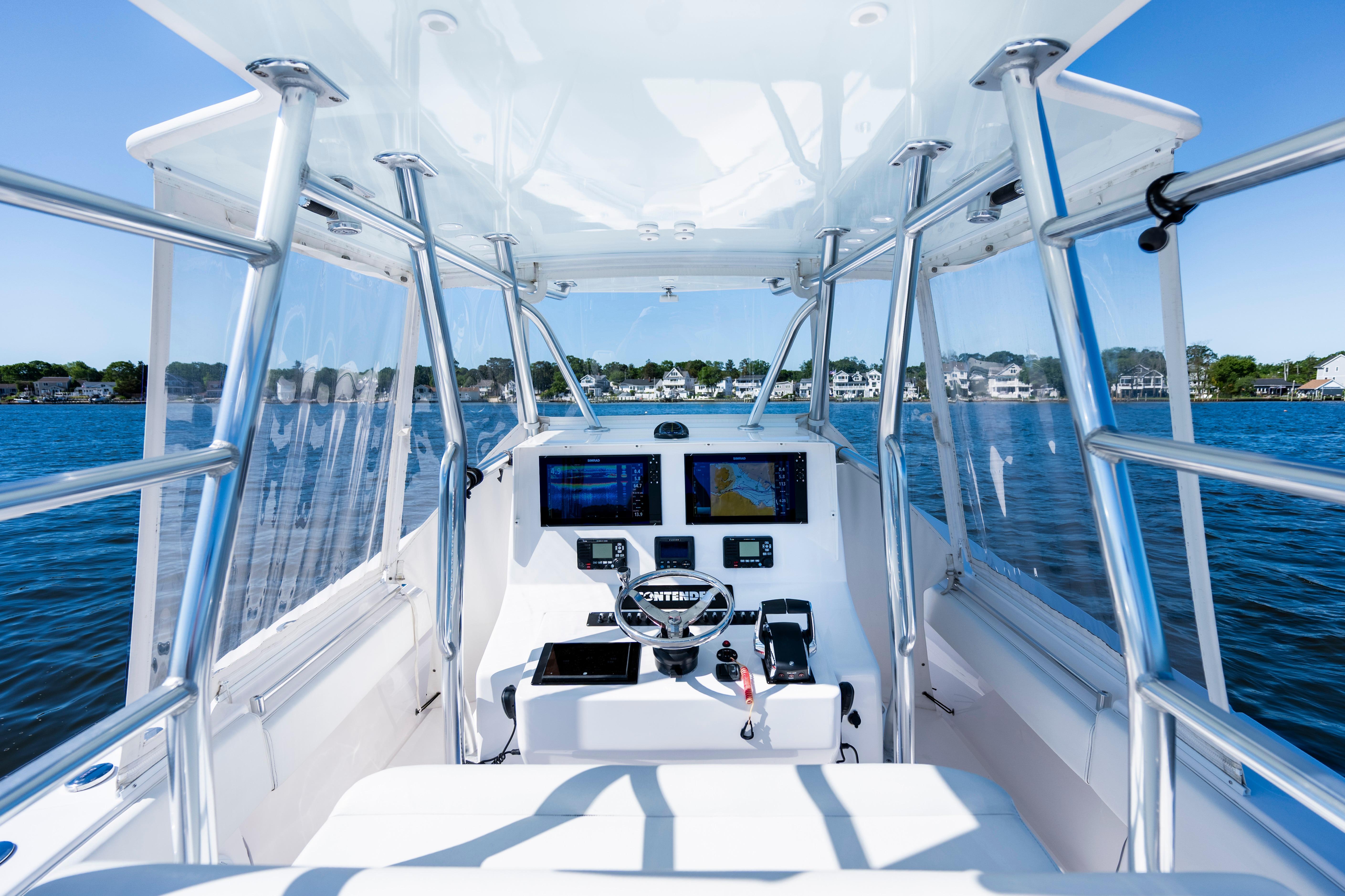 2015 Contender 39 ST boat cockpit with navigation screens on a sunny day.