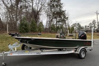 2025 Mako 18 Pro Skiff Backwater Edition on trailer, parked outdoors.