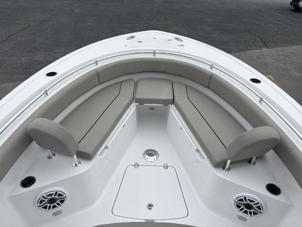 2025 Sportsman Open 232 boat interior with cushioned seating and speakers.