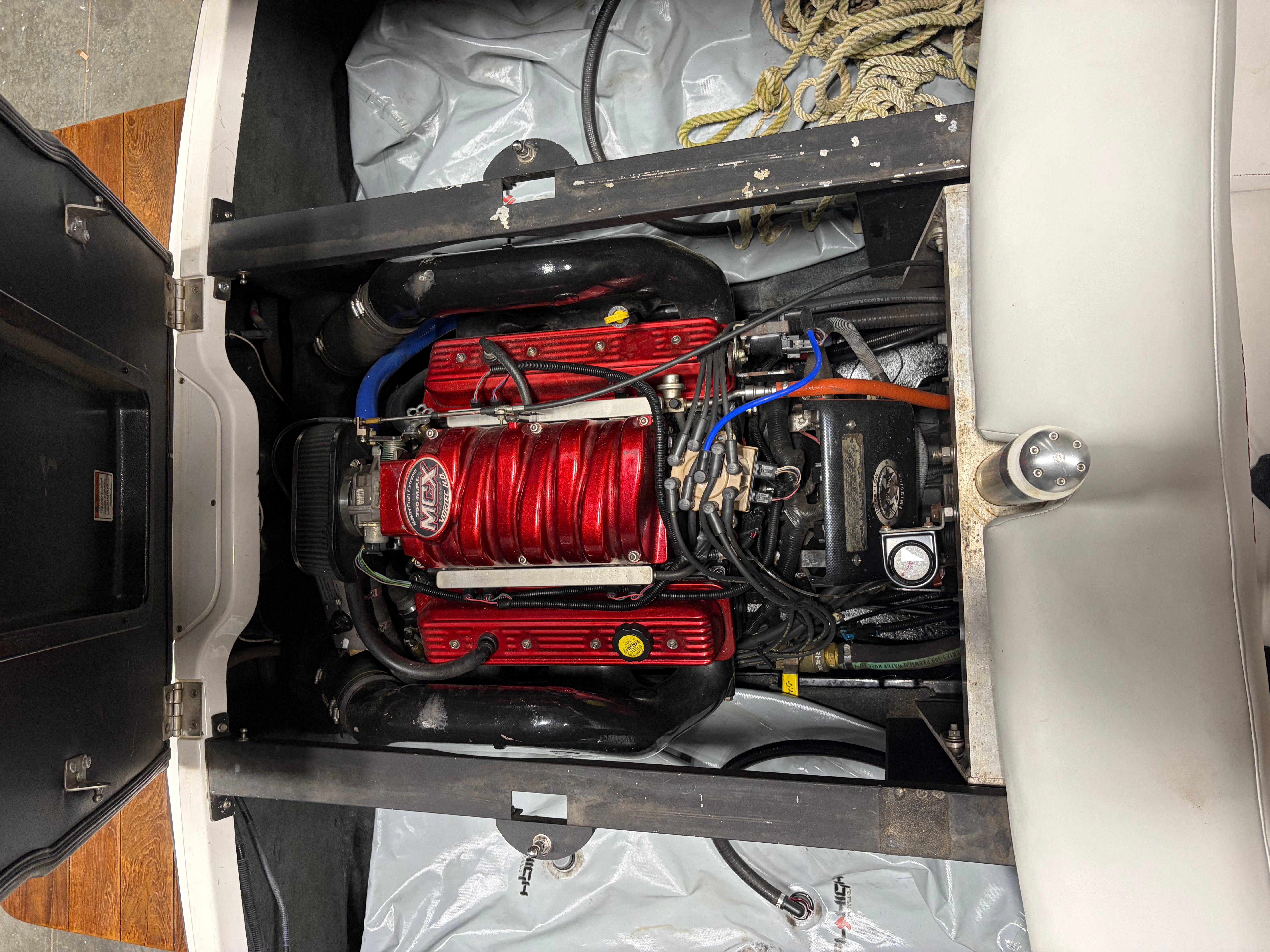 Engine compartment of a 2004 MasterCraft X2 boat with red engine.