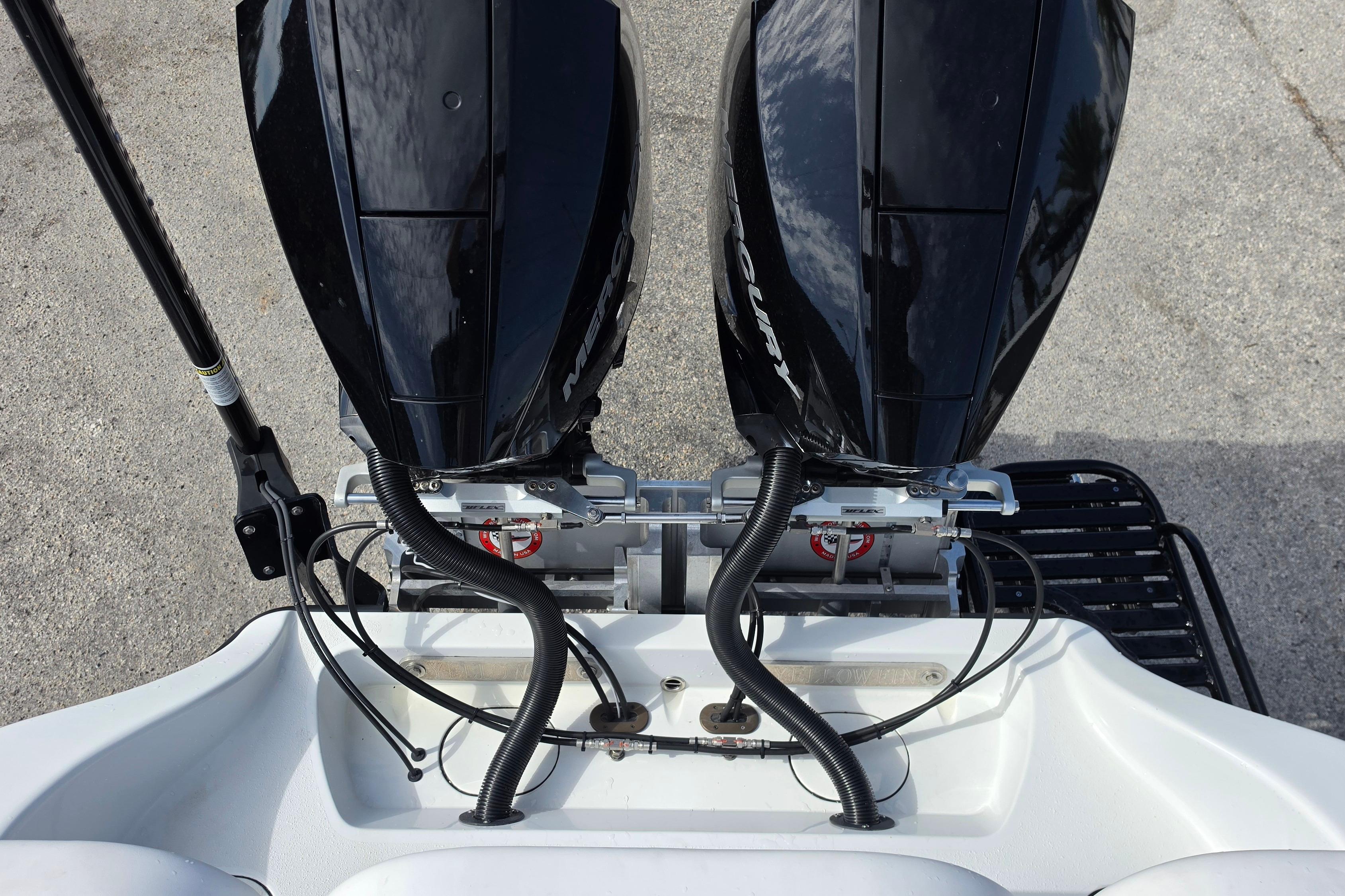 Twin Mercury outboard engines on a 2025 Yellowfin 26 Hybrid boat, viewed from above.