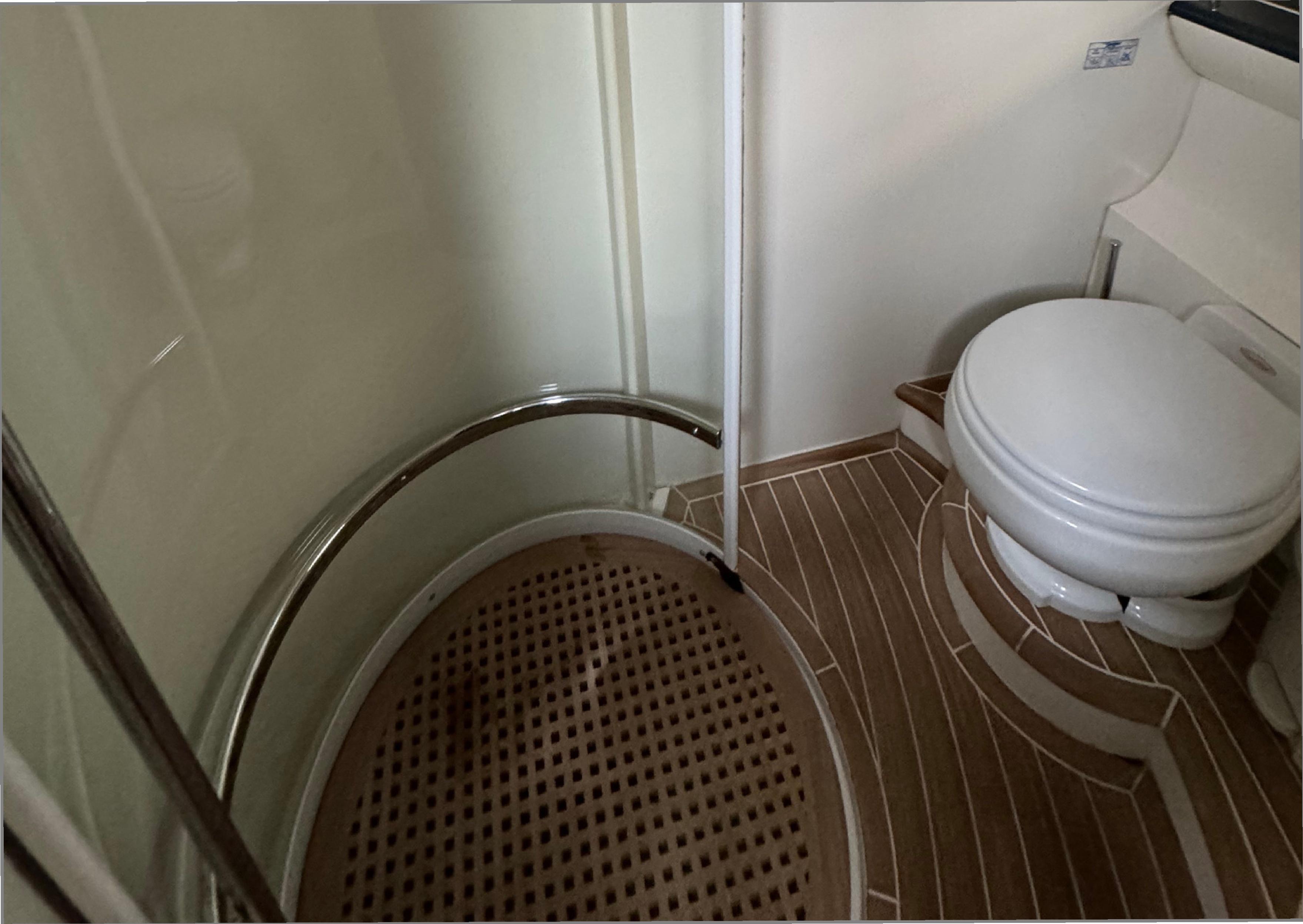 Bathroom interior of 2004 Princess V65 yacht with shower and toilet.