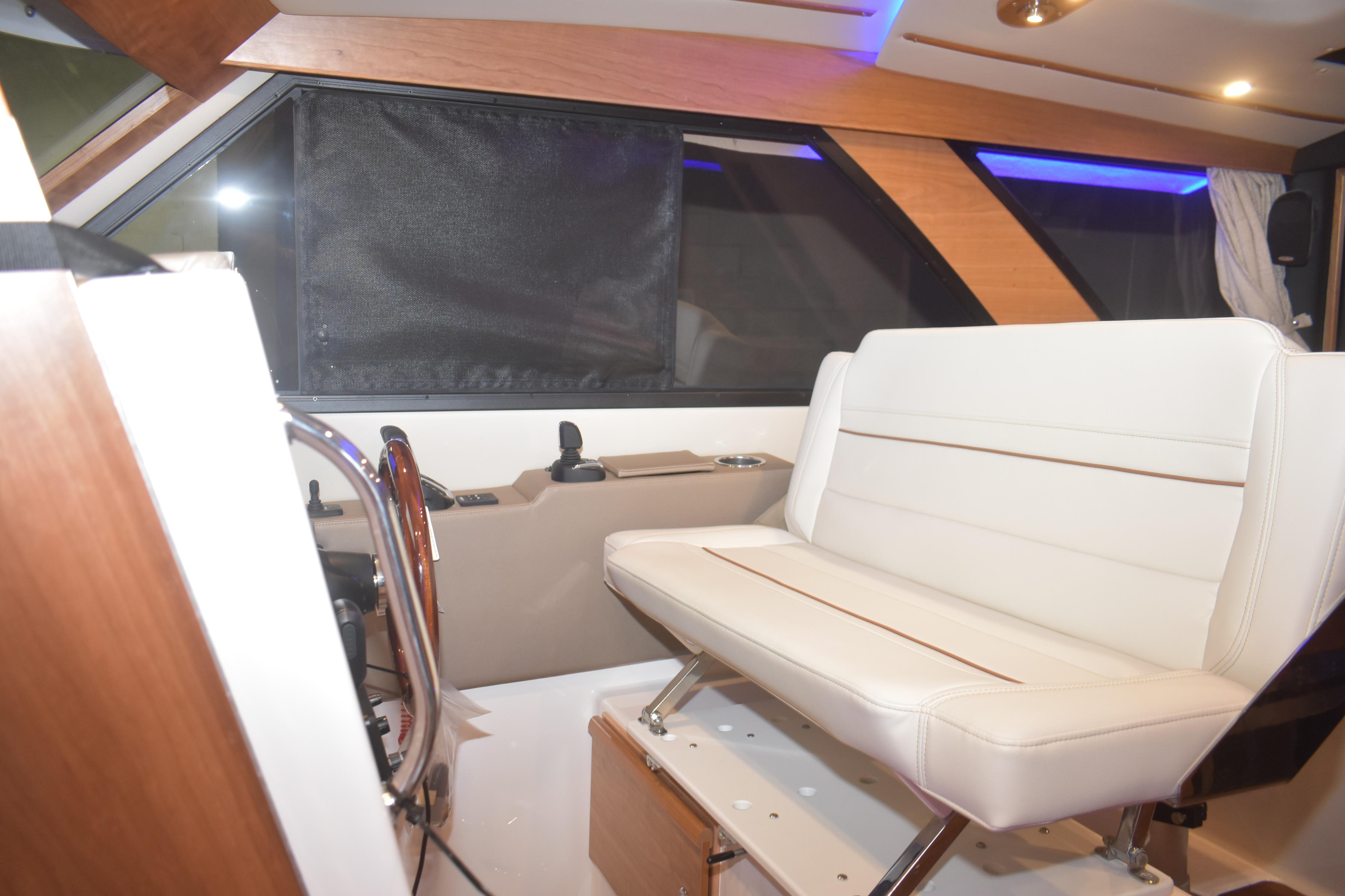 Interior of 2026 Cutwater C-32 CB boat with white seating and modern design.