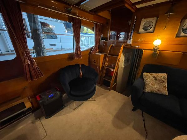 Interior of a 1951 Chris-Craft Catalina boat with cozy seating and vintage decor.