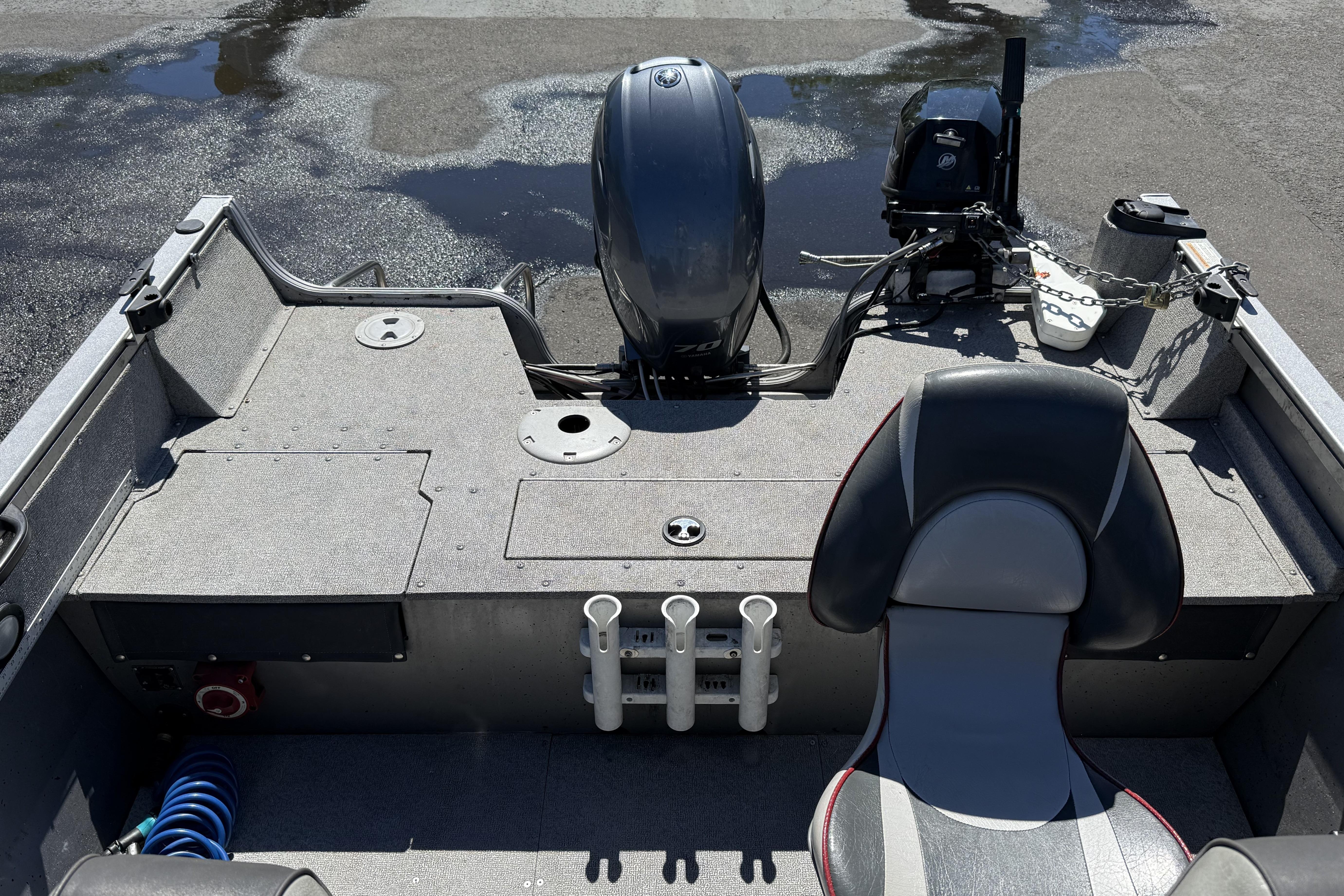 2016 Crestliner 1700 Vision boat interior with motor and seating, showcasing fishing rod holders.