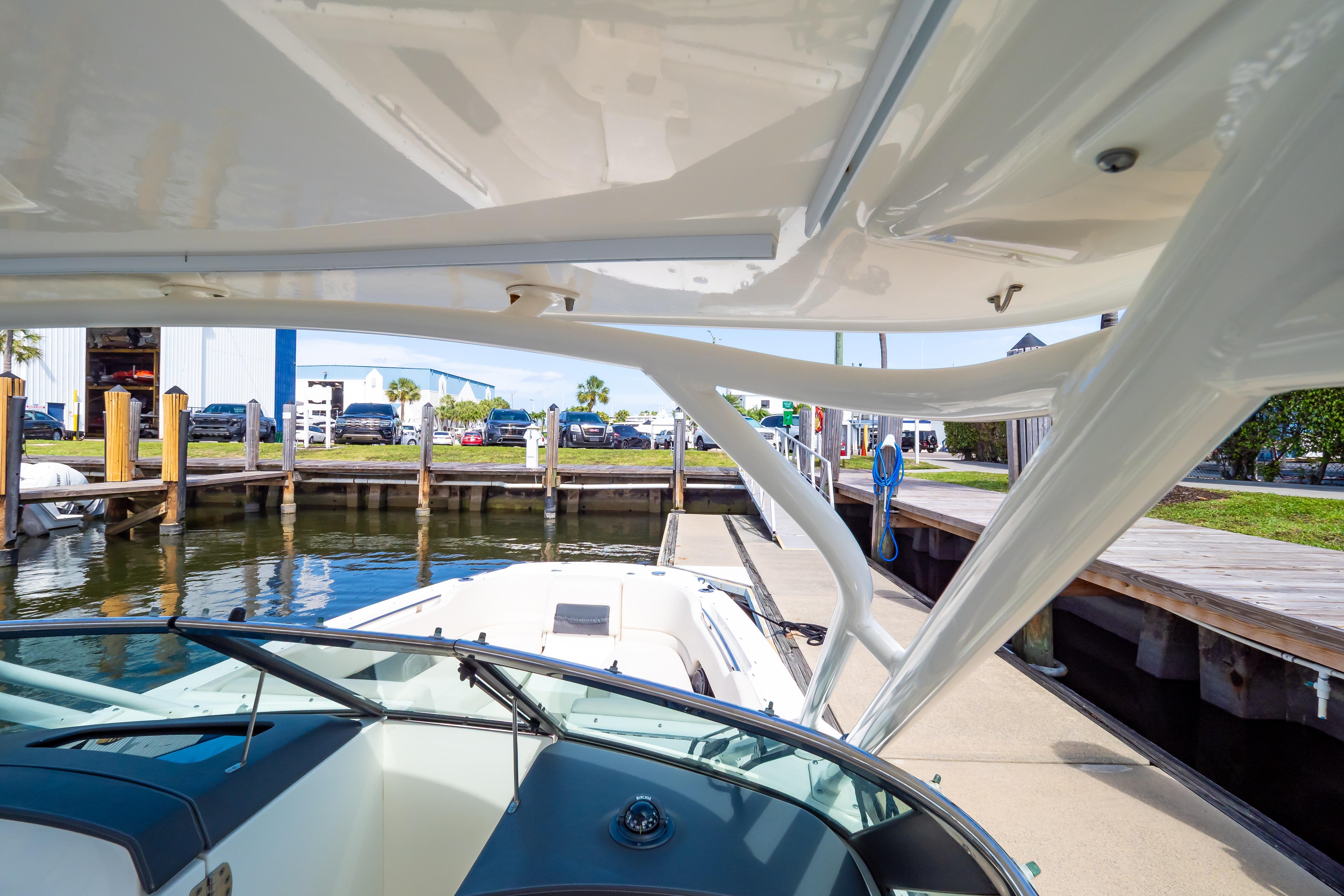 2019 Boston Whaler 270 Vantage docked at marina, showcasing sleek design and waterfront setting.