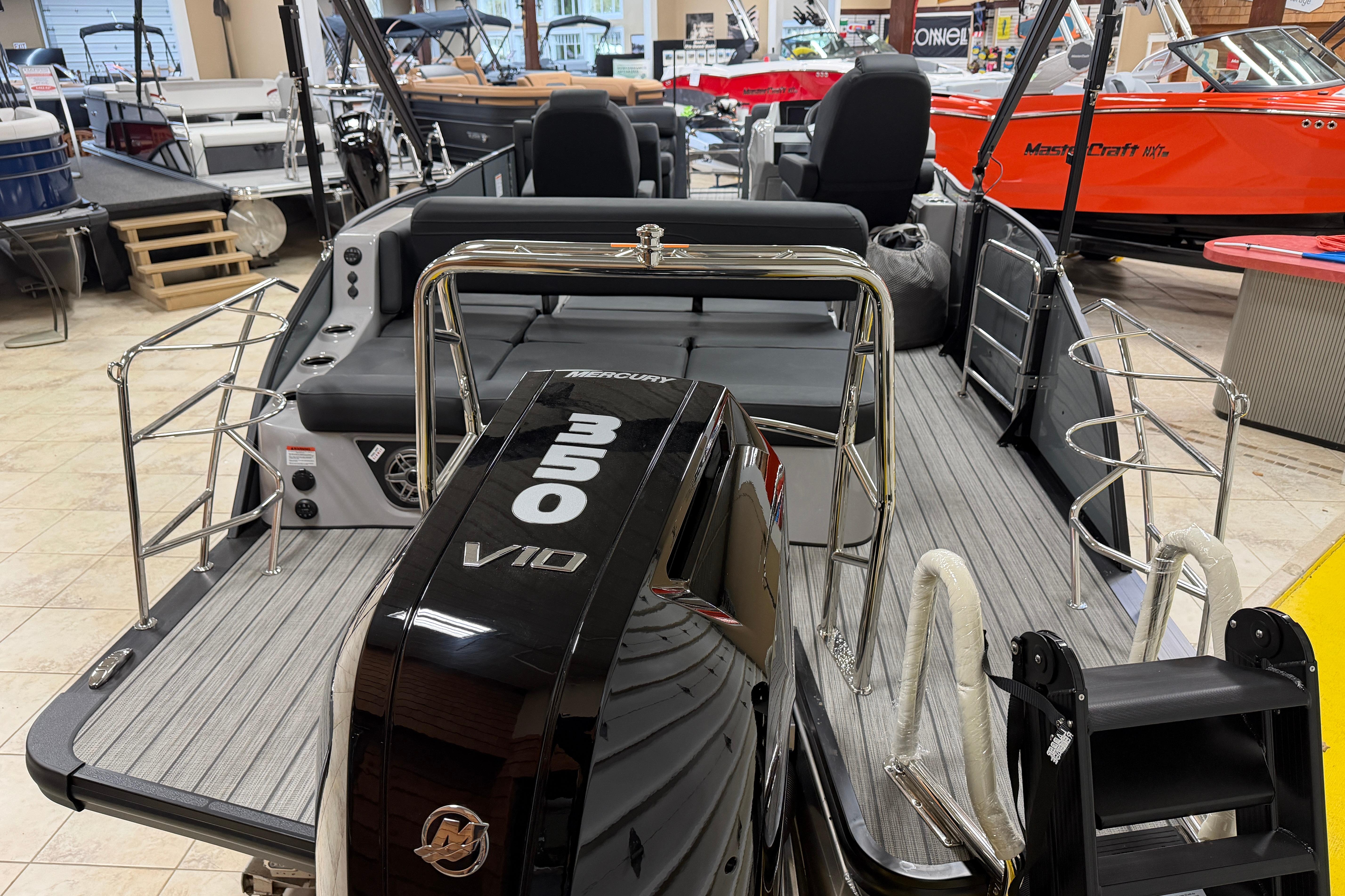 2026 Harris Grand Mariner 250 boat with Mercury 350 V10 engine in showroom.