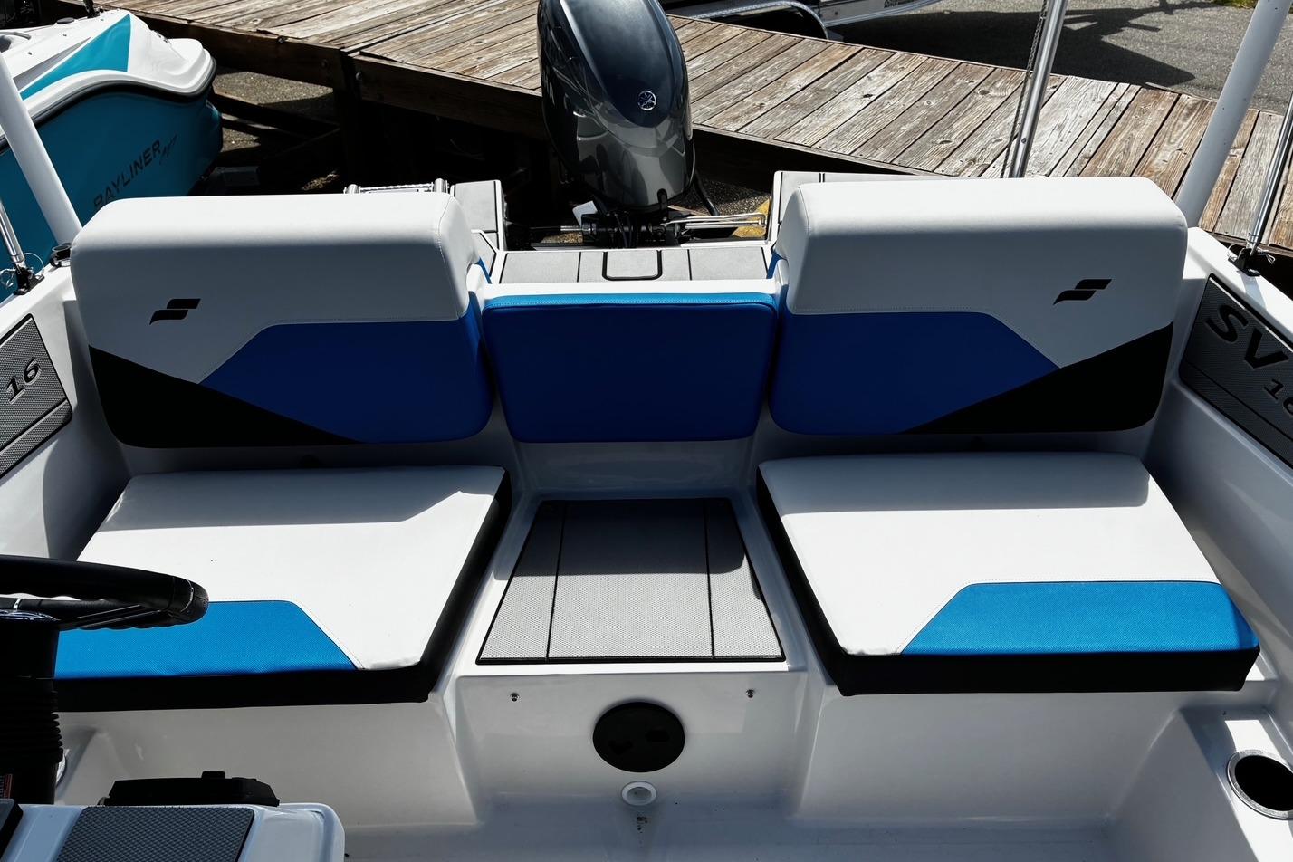 2026 Starcraft SV 16 OB boat interior with blue and white seating, docked by wooden pier.