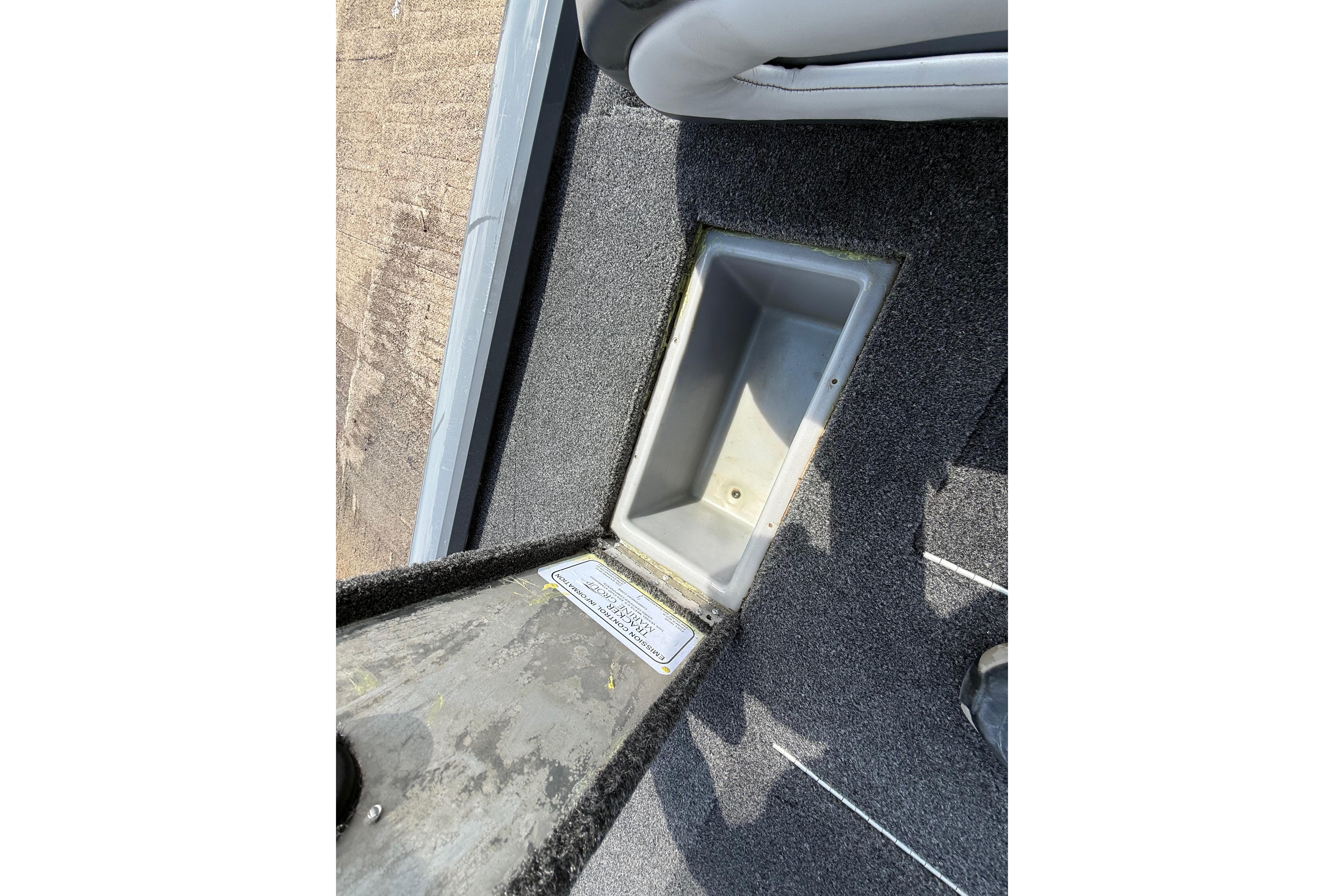 2015 Tracker Pro Team 190 TX boat storage compartment with carpeted interior.