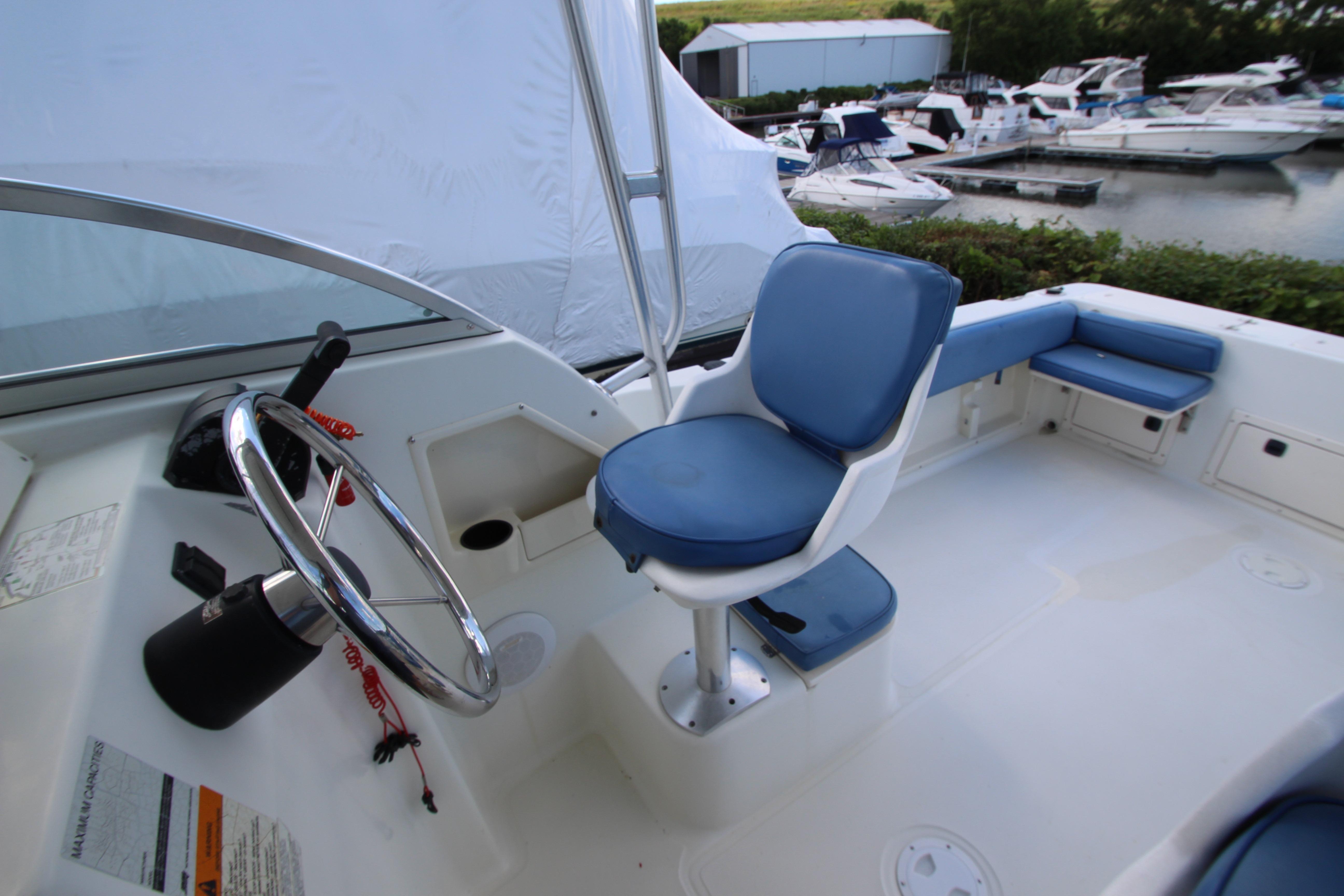 2002 Hydra-Sports 230 WA boat interior with blue seating and steering wheel.