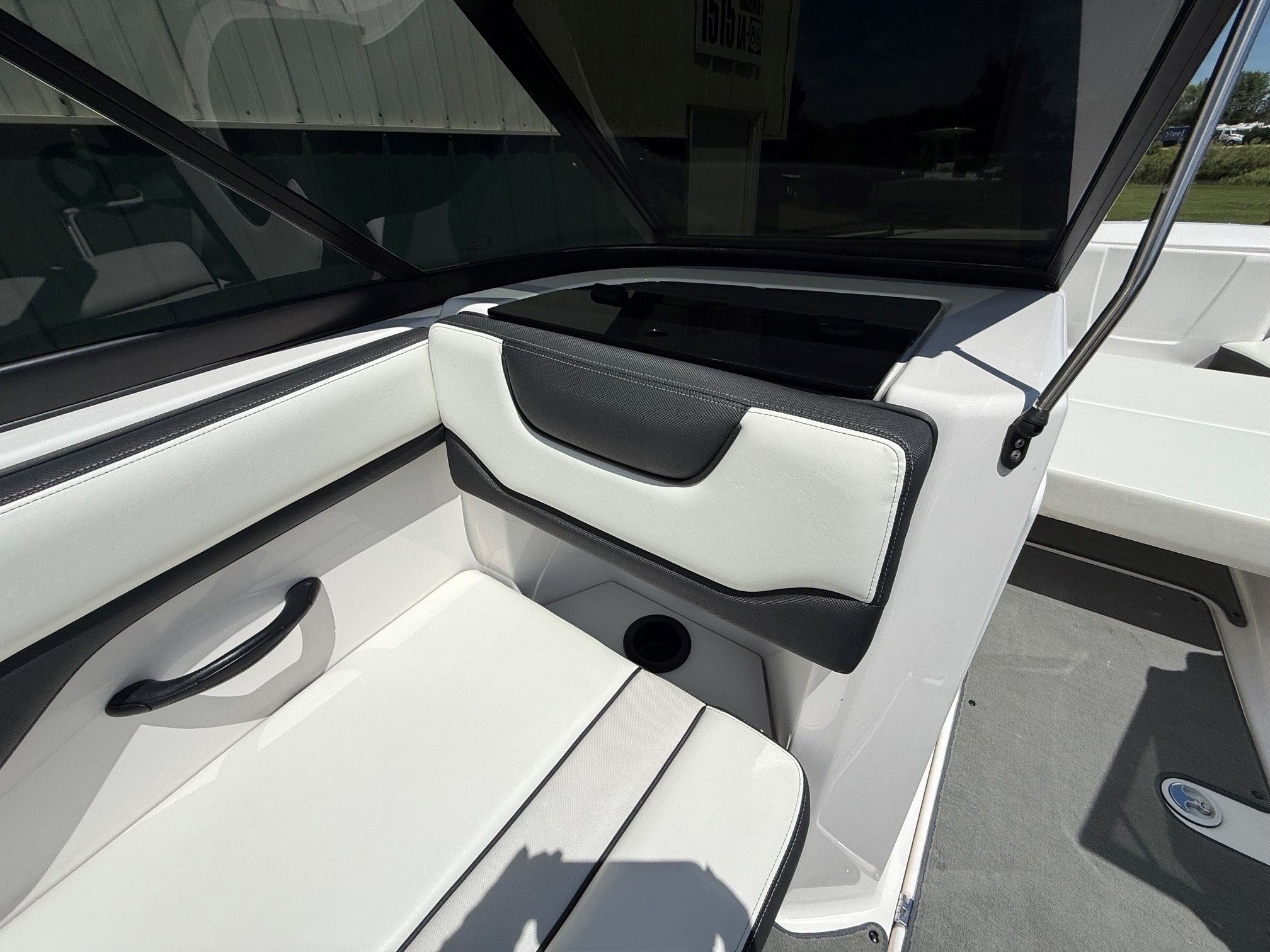 Interior view of a Yamaha SX210 boat with white and black seating.