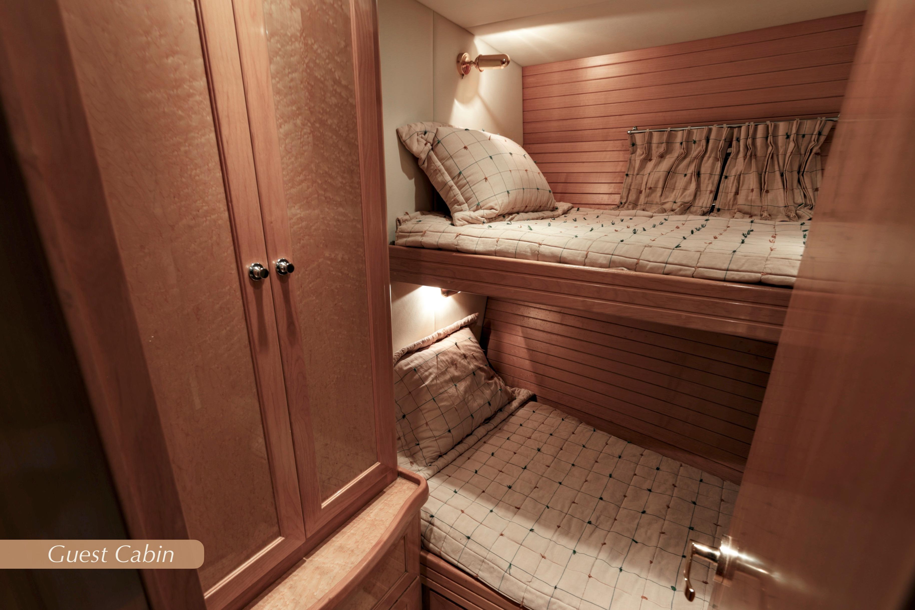 Guest cabin with bunk beds in 2004 McKinna 57 Pilothouse yacht.