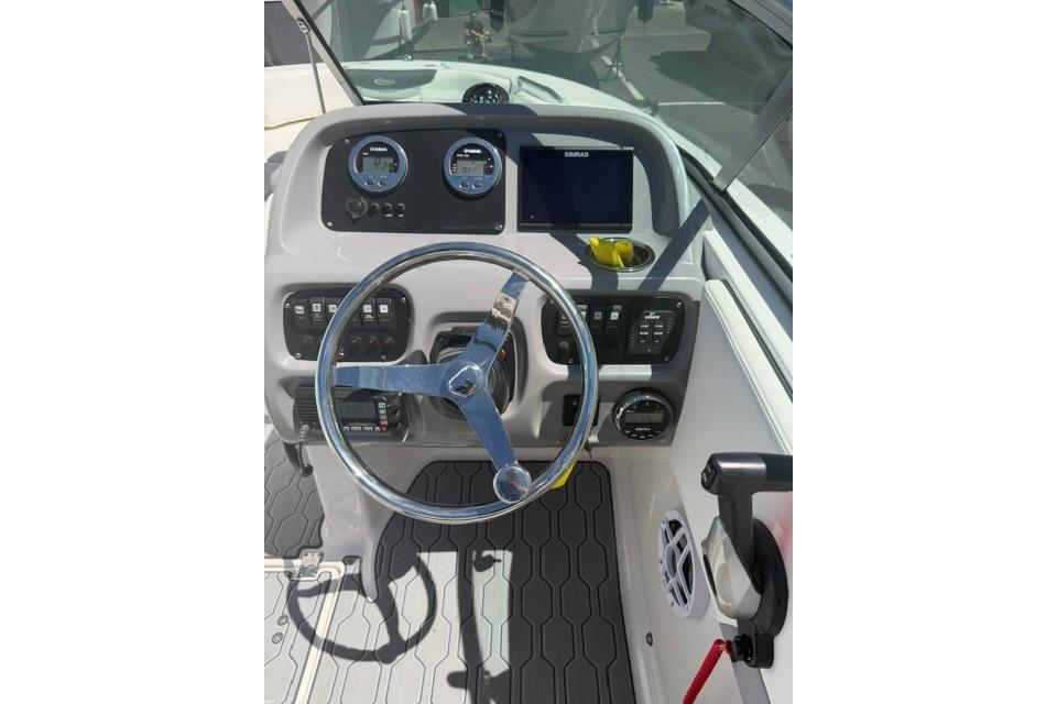 2024 Robalo R207 Dual Console boat dashboard with steering wheel and control panel.