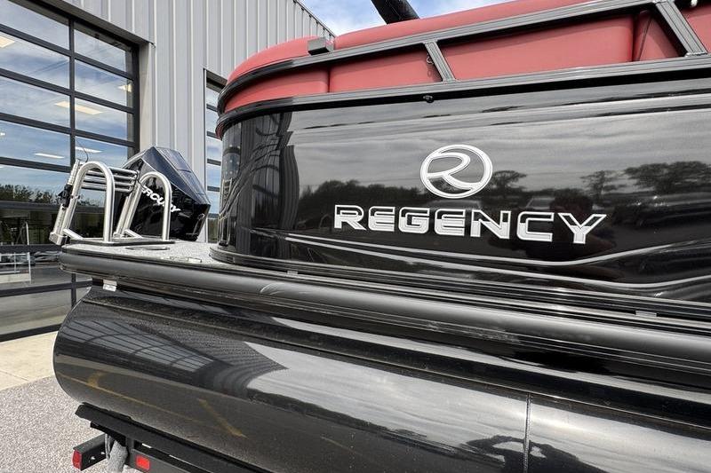 2026 Regency 230 DL boat with sleek black exterior and red accents.
