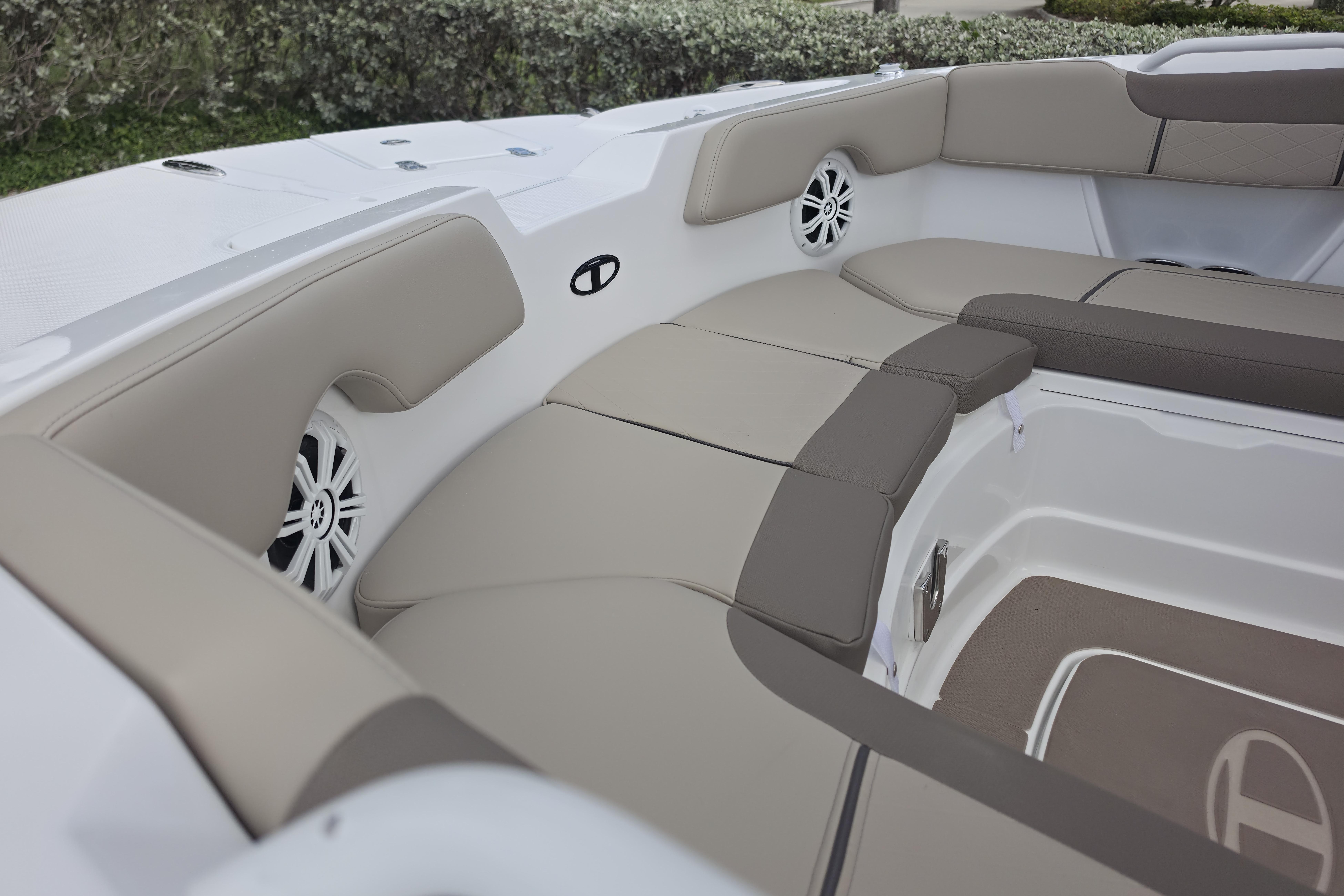 Interior seating of 2026 Tahoe 2150 CC boat with beige cushions and speakers.