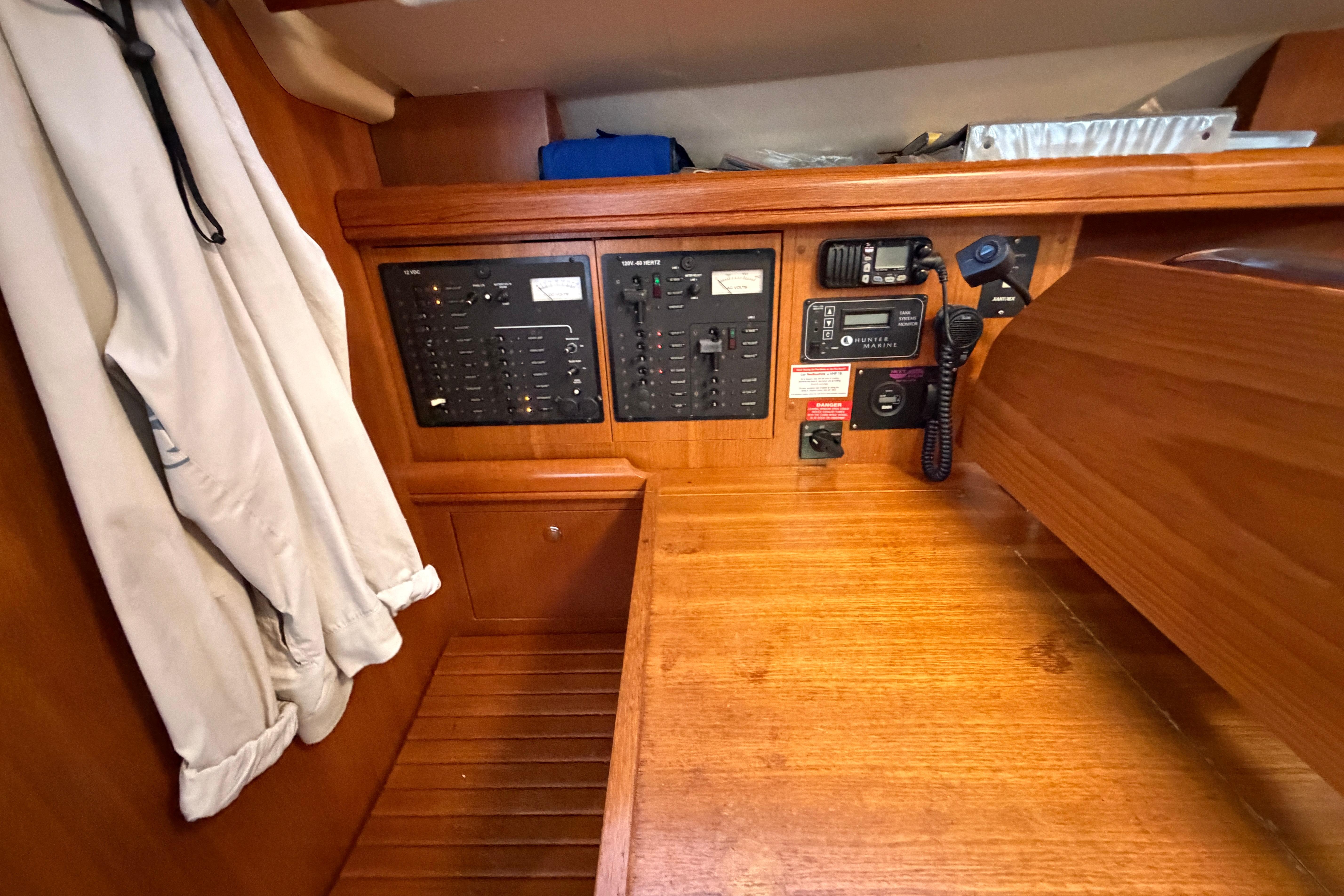 Control panel of a 2005 Hunter 38 sailboat with communication equipment.