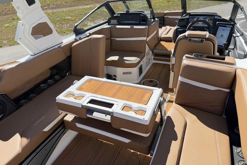 Luxurious interior of 2026 Supra SL boat with tan leather seating and modern dashboard.