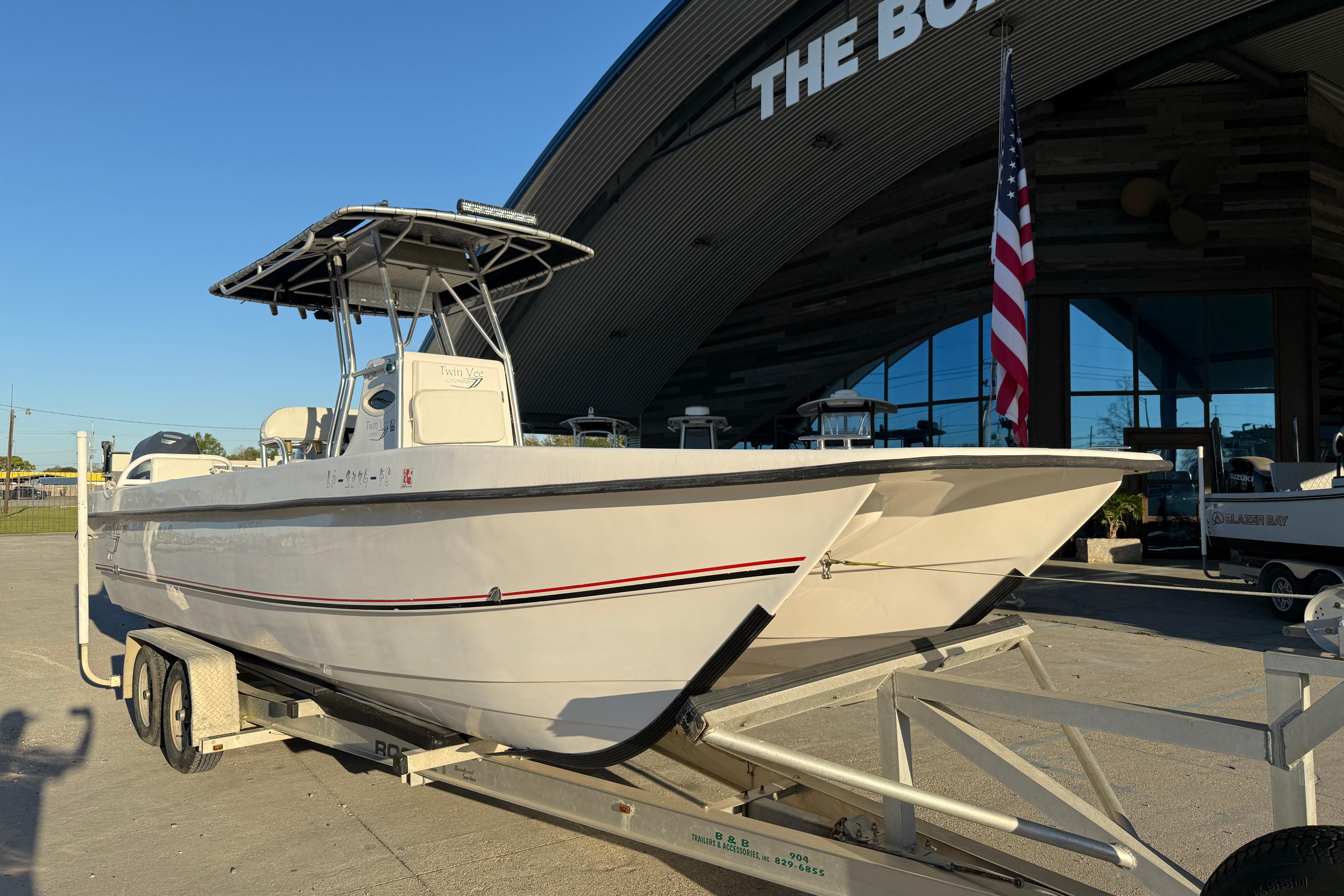 2007 Twin Vee 26 Center Console boat on trailer outside dealership.
