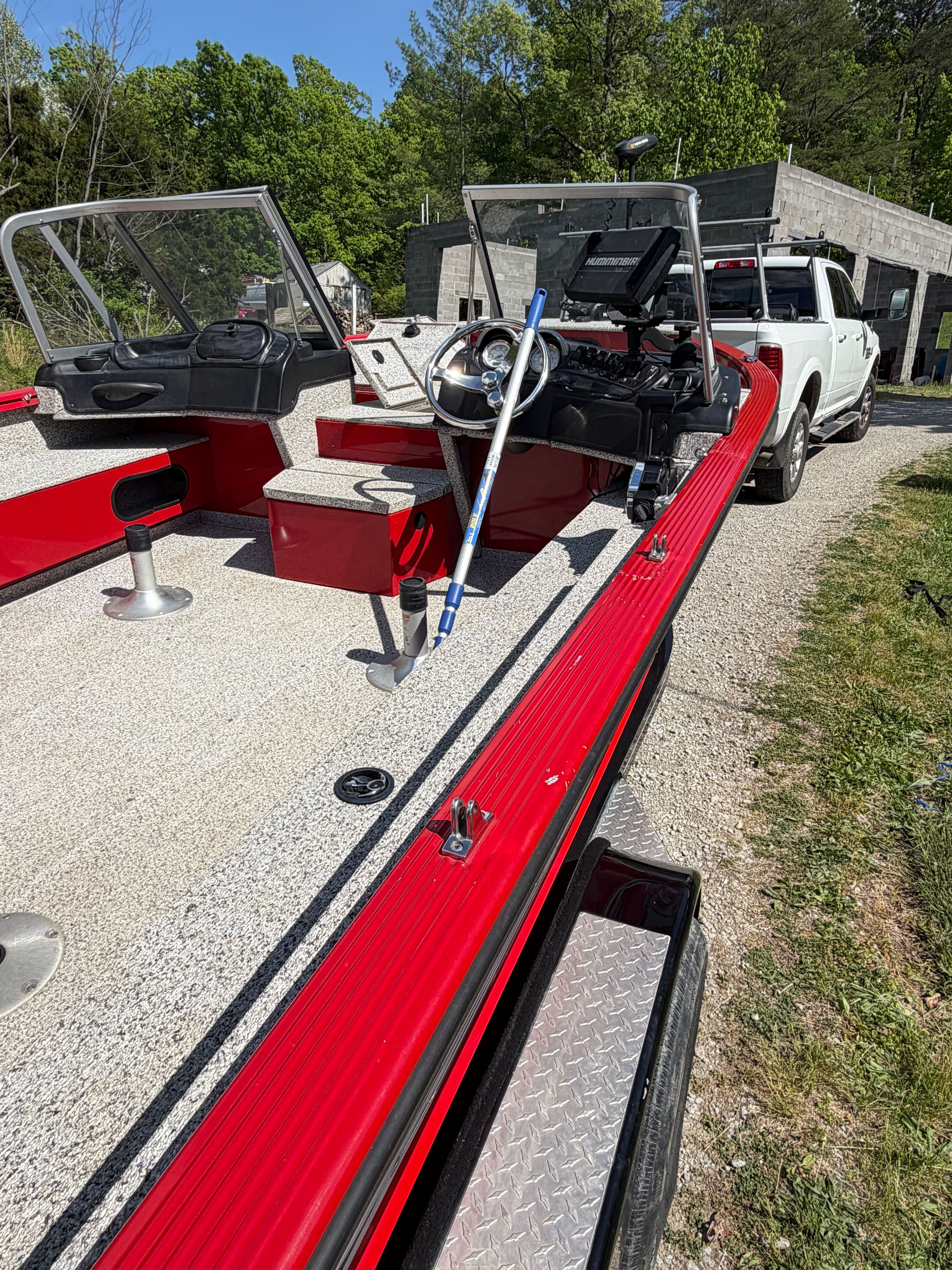 Polar Kraft Outlander 2010 boat, 2024 model, on trailer beside white vehicle.