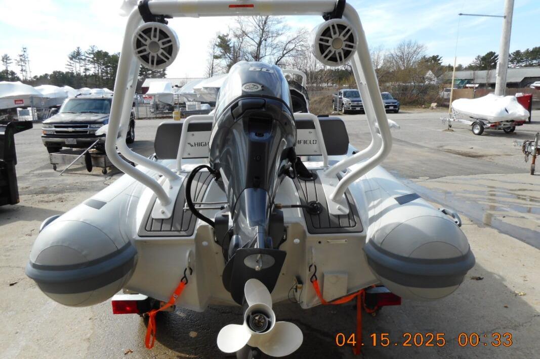 2025 Highfield Sport 420 inflatable boat with motor, parked outdoors.