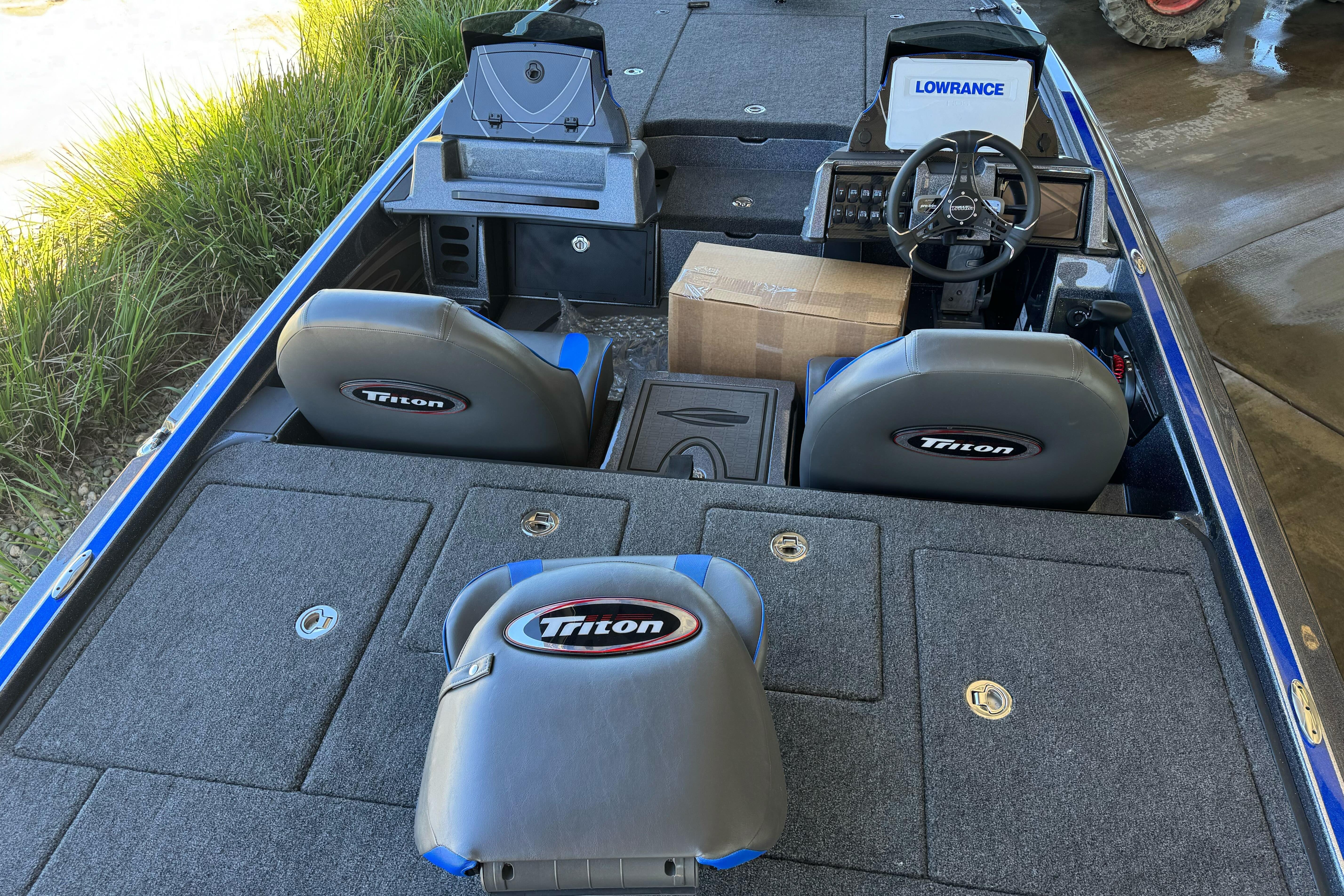 2026 Triton 21XP Patriot boat interior with steering wheel and seating.