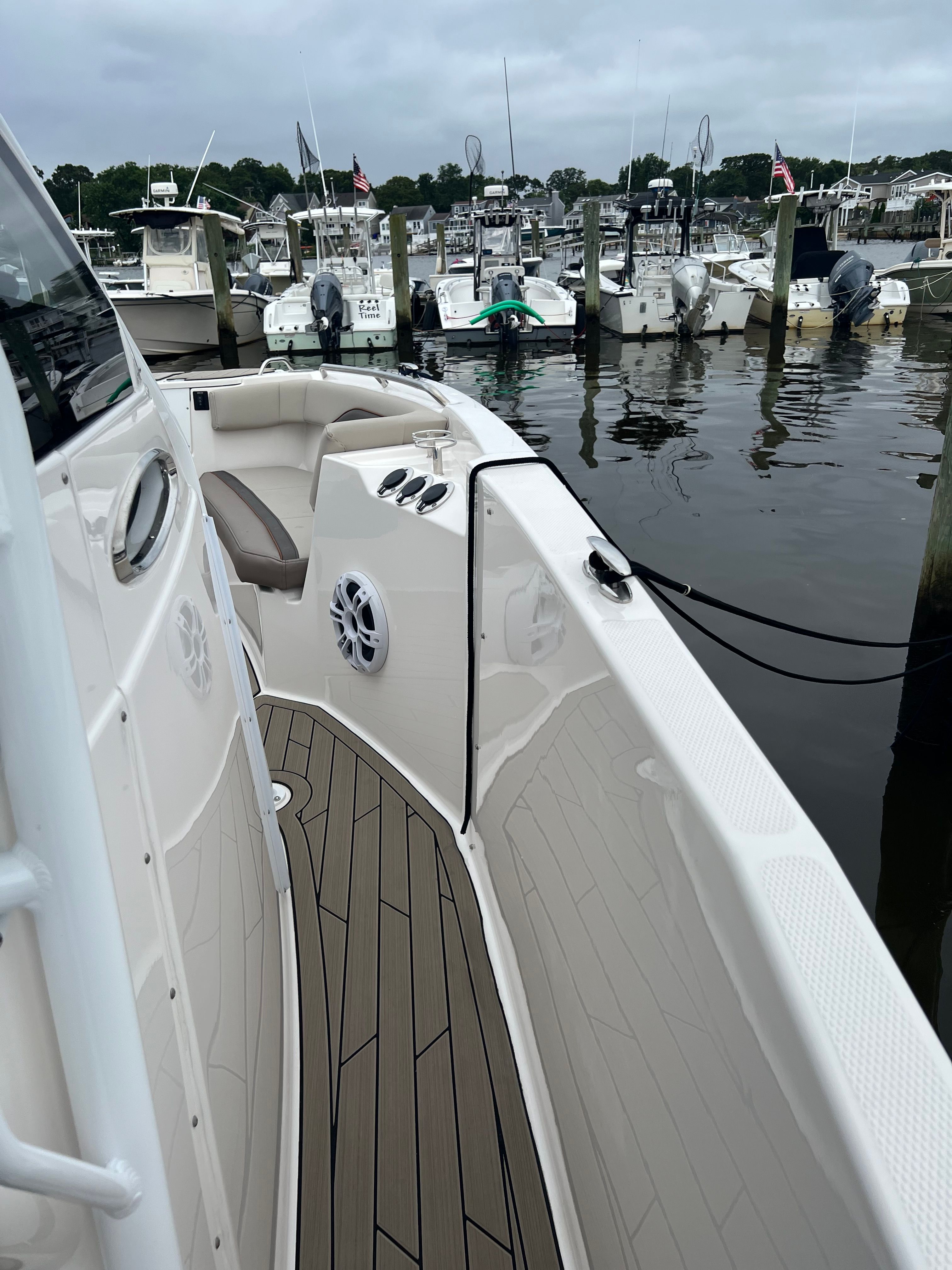 A 2022 Cutwater C-24 CW is docked at a marina. It features a sleek deck design.