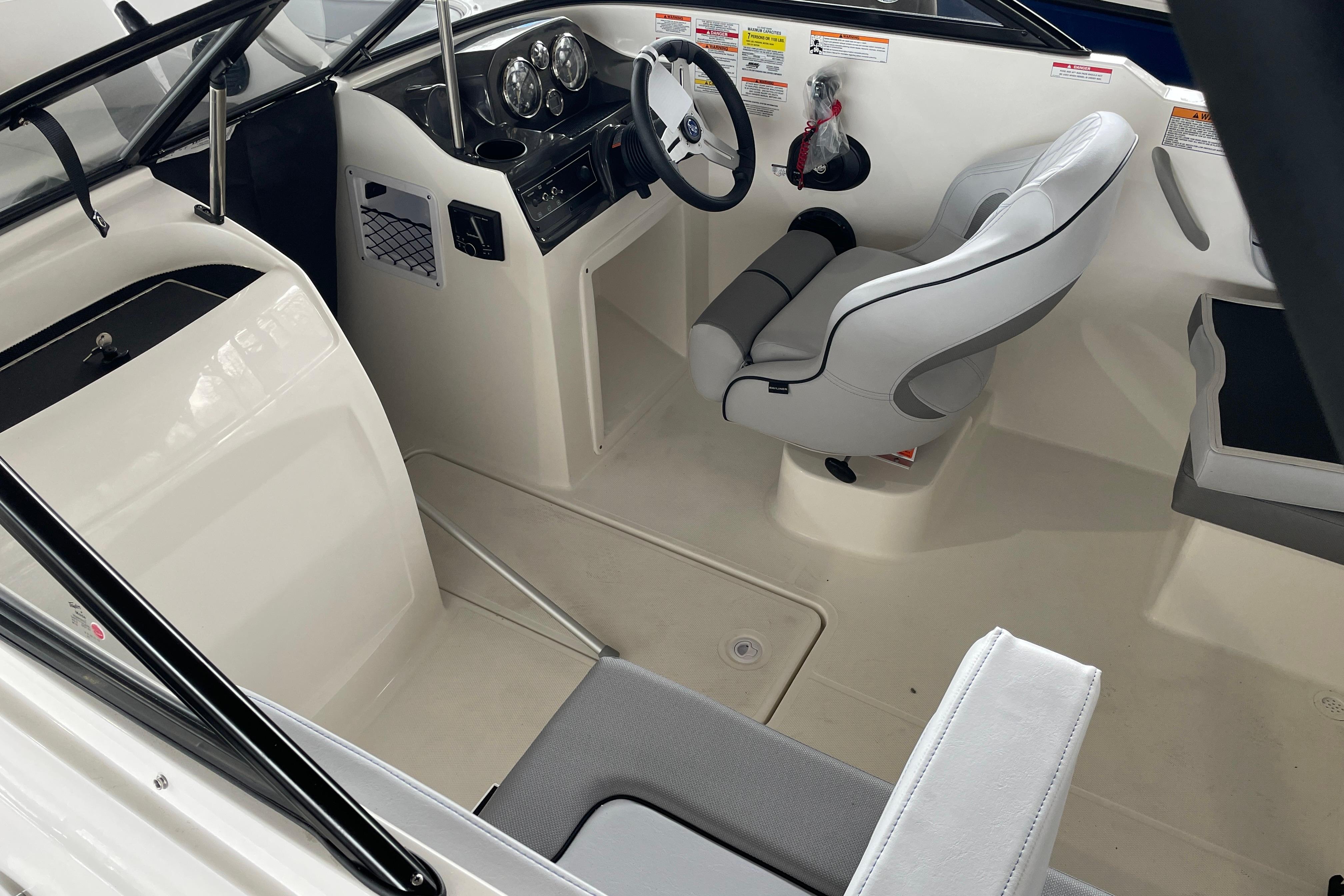2026 Bayliner VR4 Bowrider OB interior with steering wheel and seating.