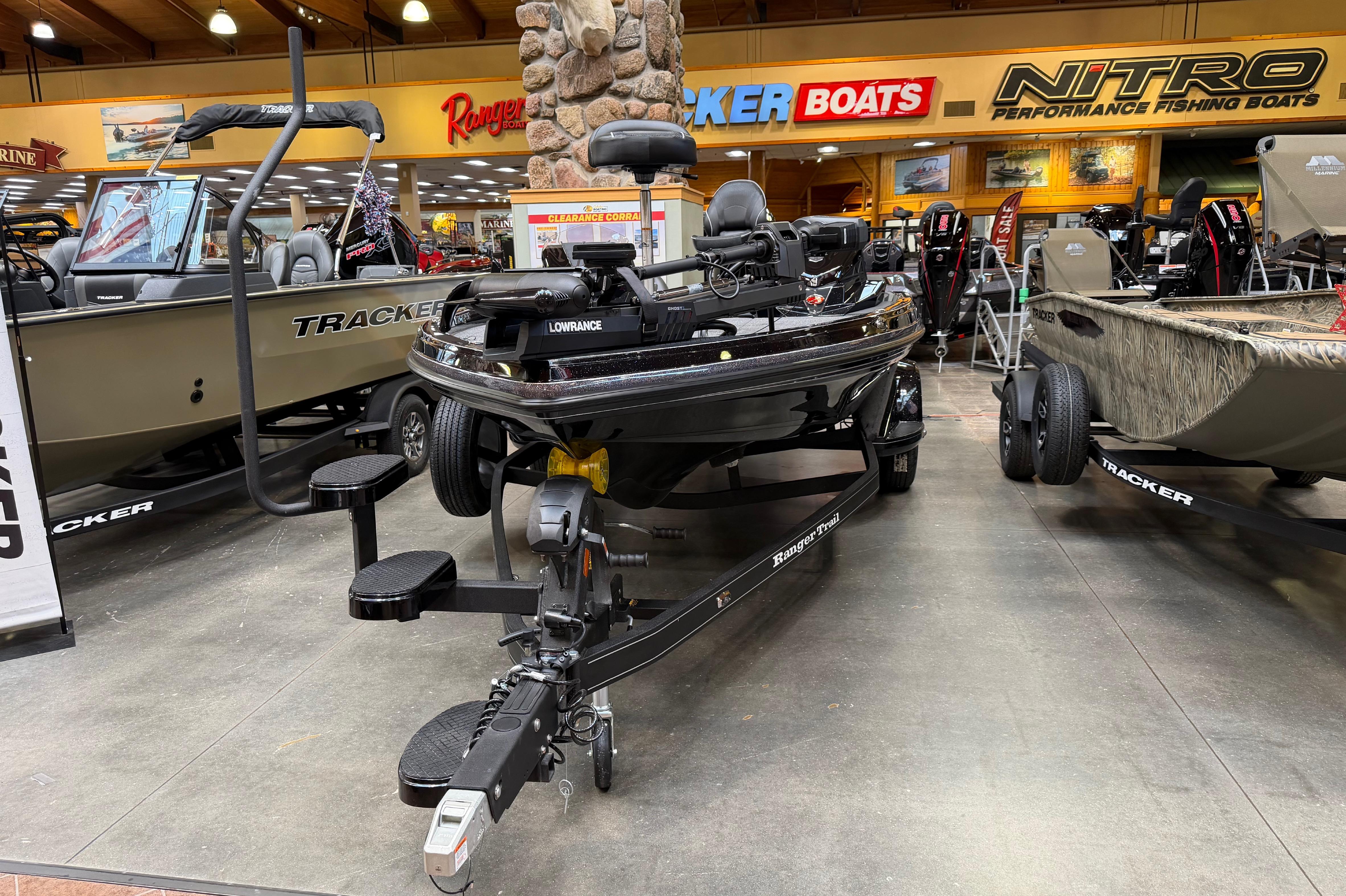2026 Ranger Z518 fishing boat displayed in showroom with Tracker and Nitro boats.