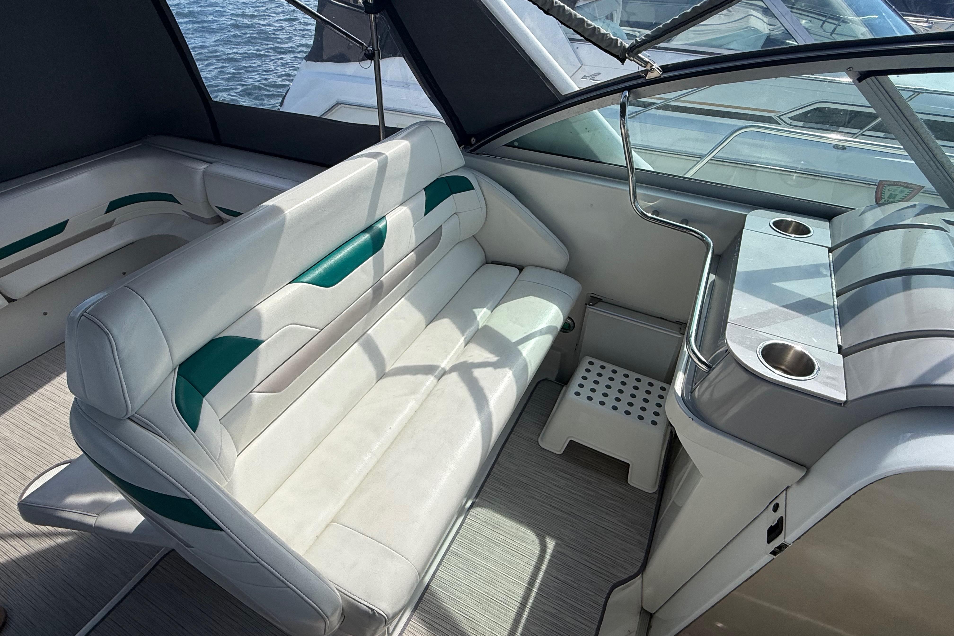 Interior of a 1999 Formula 34 Performance Cruiser with white seating and cup holders.