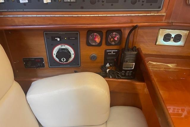 Control panel of a 2001 Tartan 3700 yacht with gauges and radio equipment.