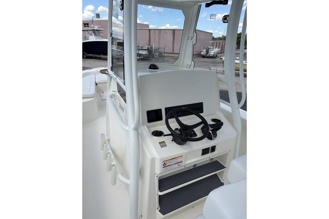 Interior view of 2026 Pathfinder 2800 Hybrid boat cockpit with steering wheel and controls.