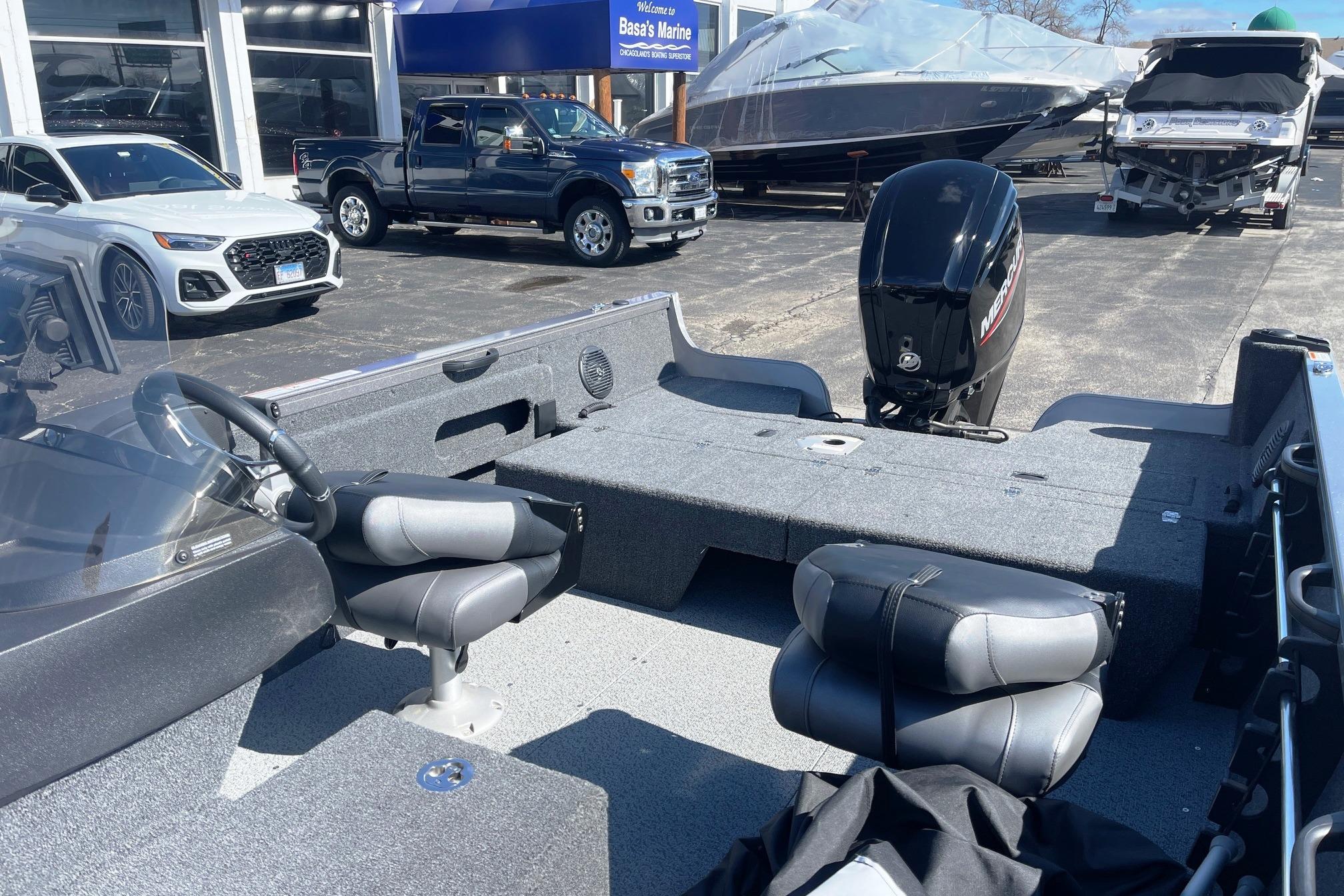 2023 Crestliner 1650 Fish Hawk boat interior with seats and motor at dealership.