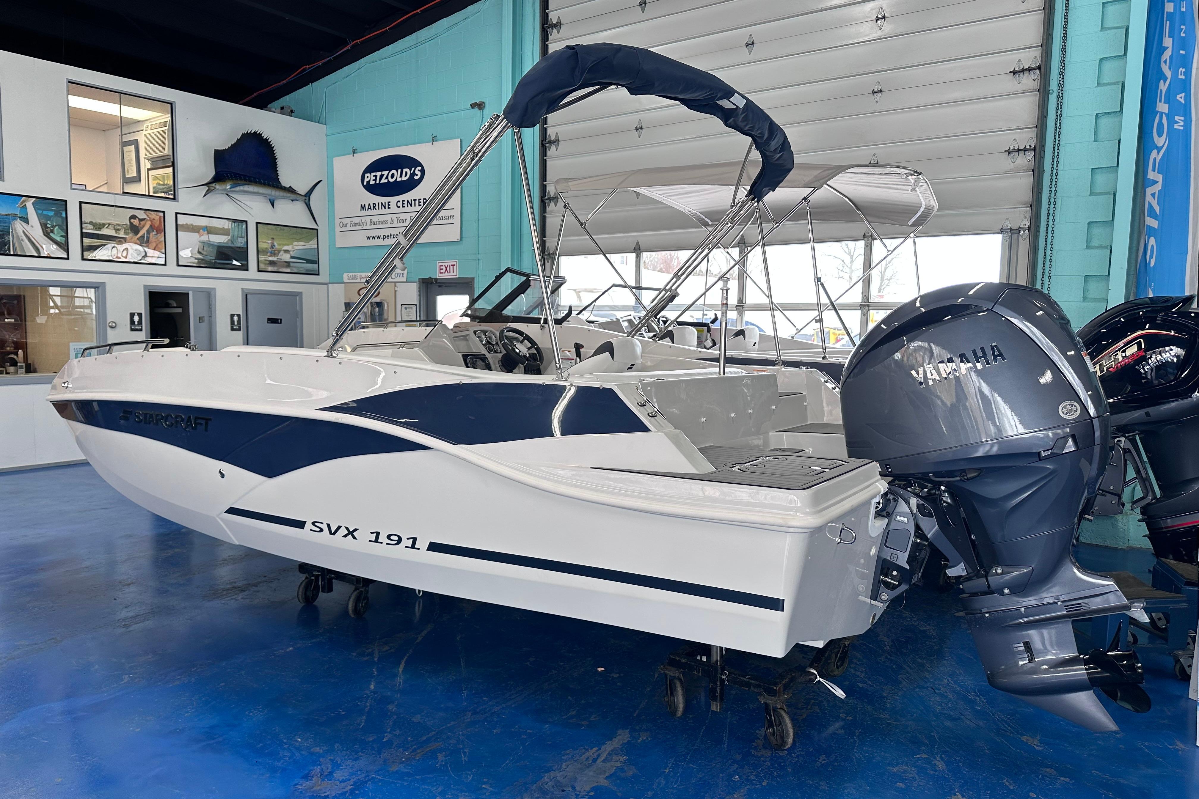 2026 Starcraft SVX 191 OB boat with Yamaha outboard motor in showroom.