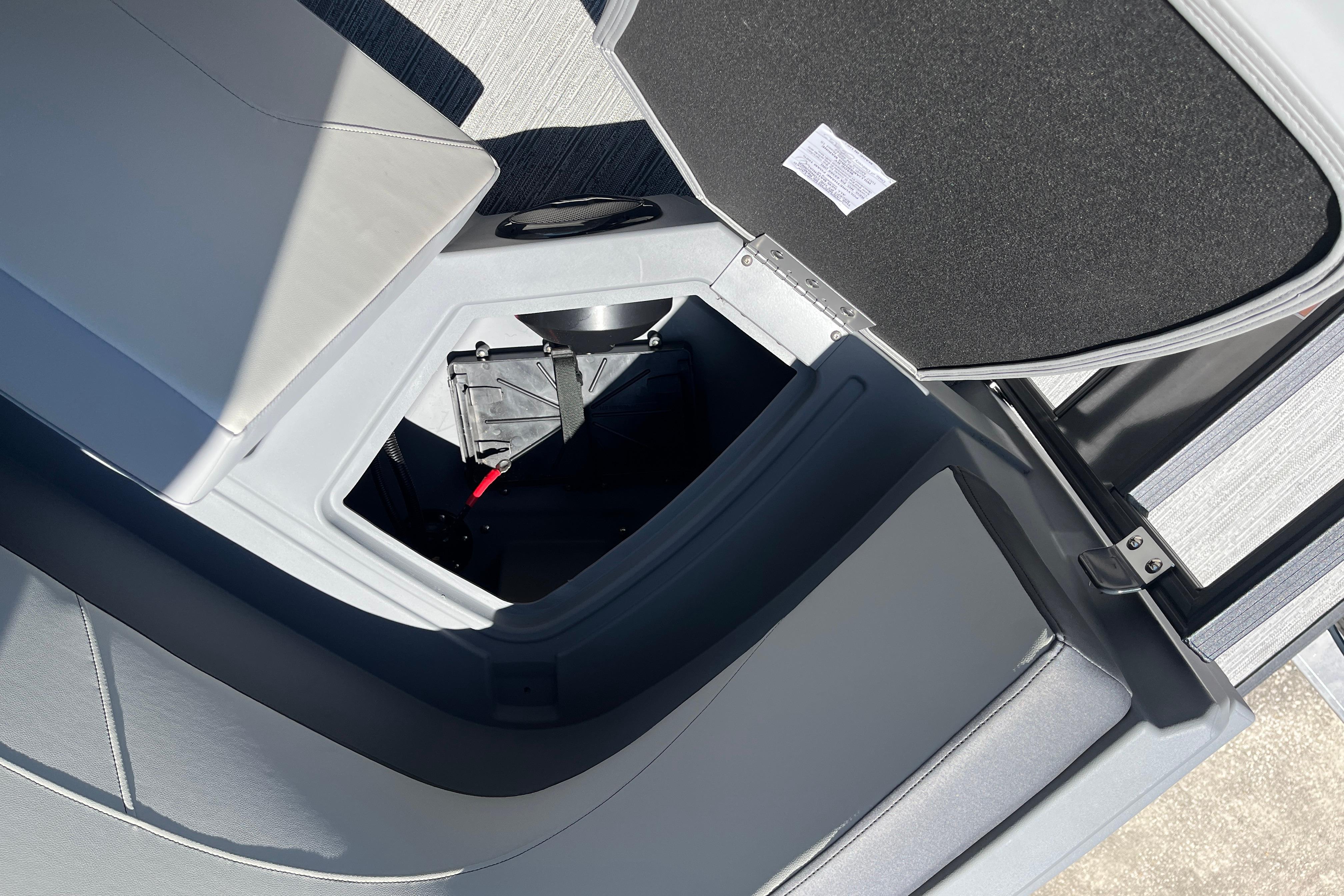 Open storage compartment in 2026 Starcraft GX 18 R boat, showcasing interior design.
