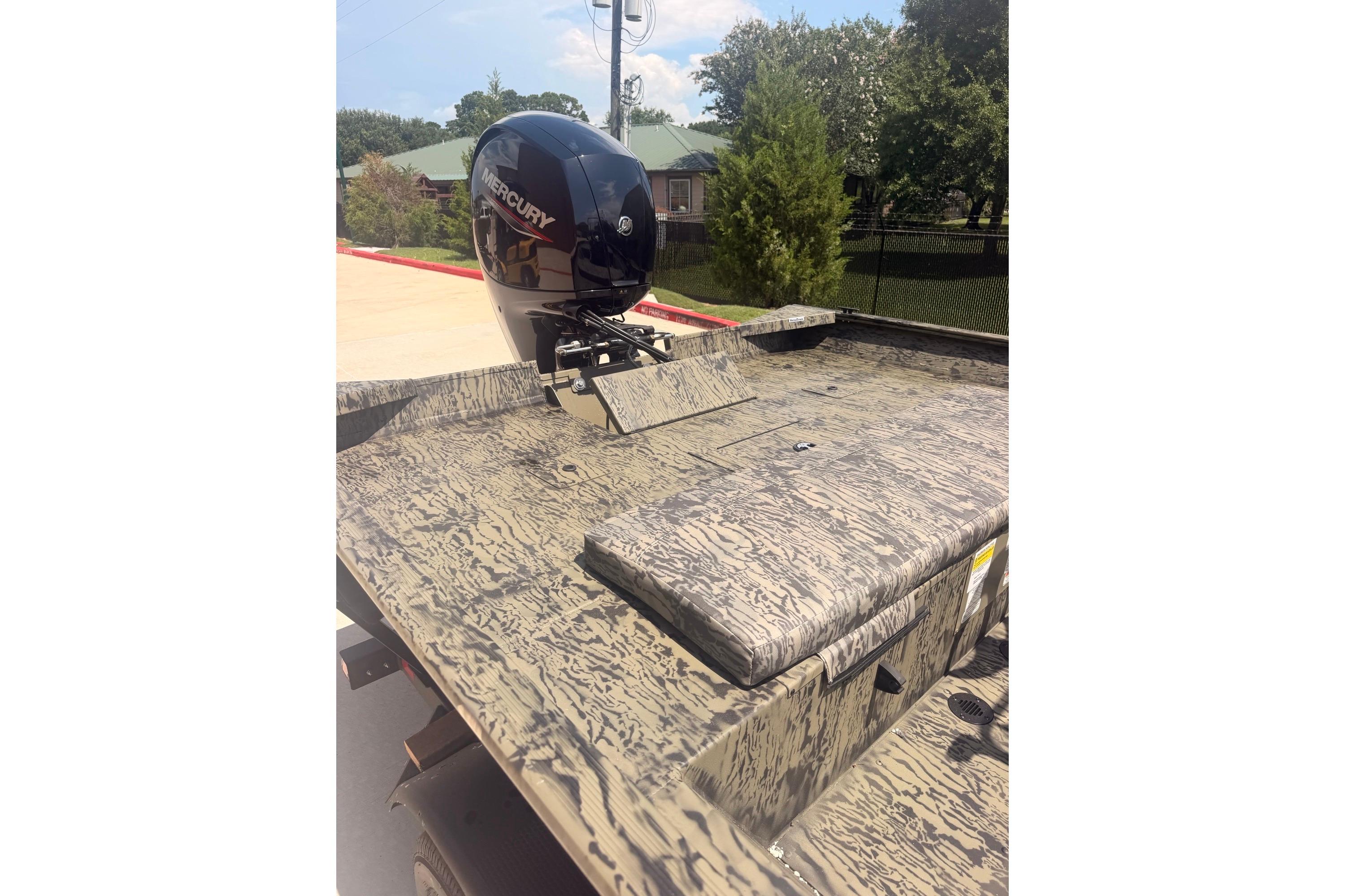2026 Tracker Grizzly 2072 CC boat with Mercury outboard motor, camo design.