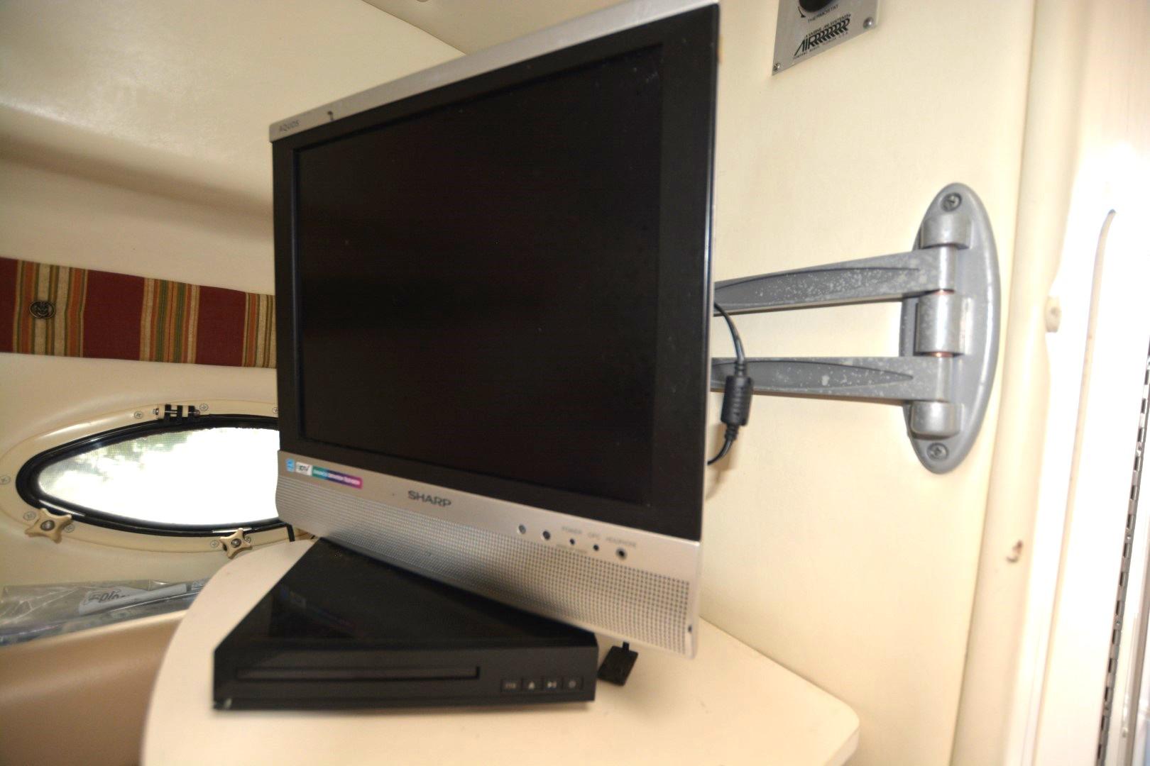 Wall-mounted Sharp TV in 1999 Rinker 270 Fiesta Vee boat interior.