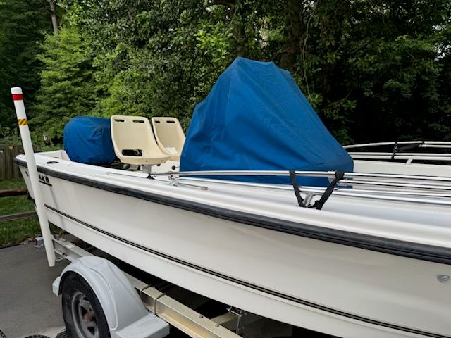 2006 Mako 171 Center Console boat on trailer in greenery.