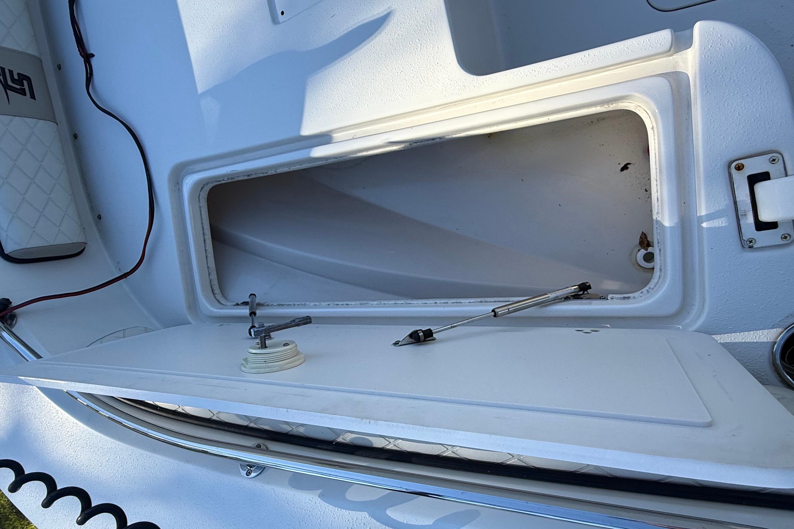 Open storage compartment on 2021 Carolina Skiff 26 Ultra Elite boat.