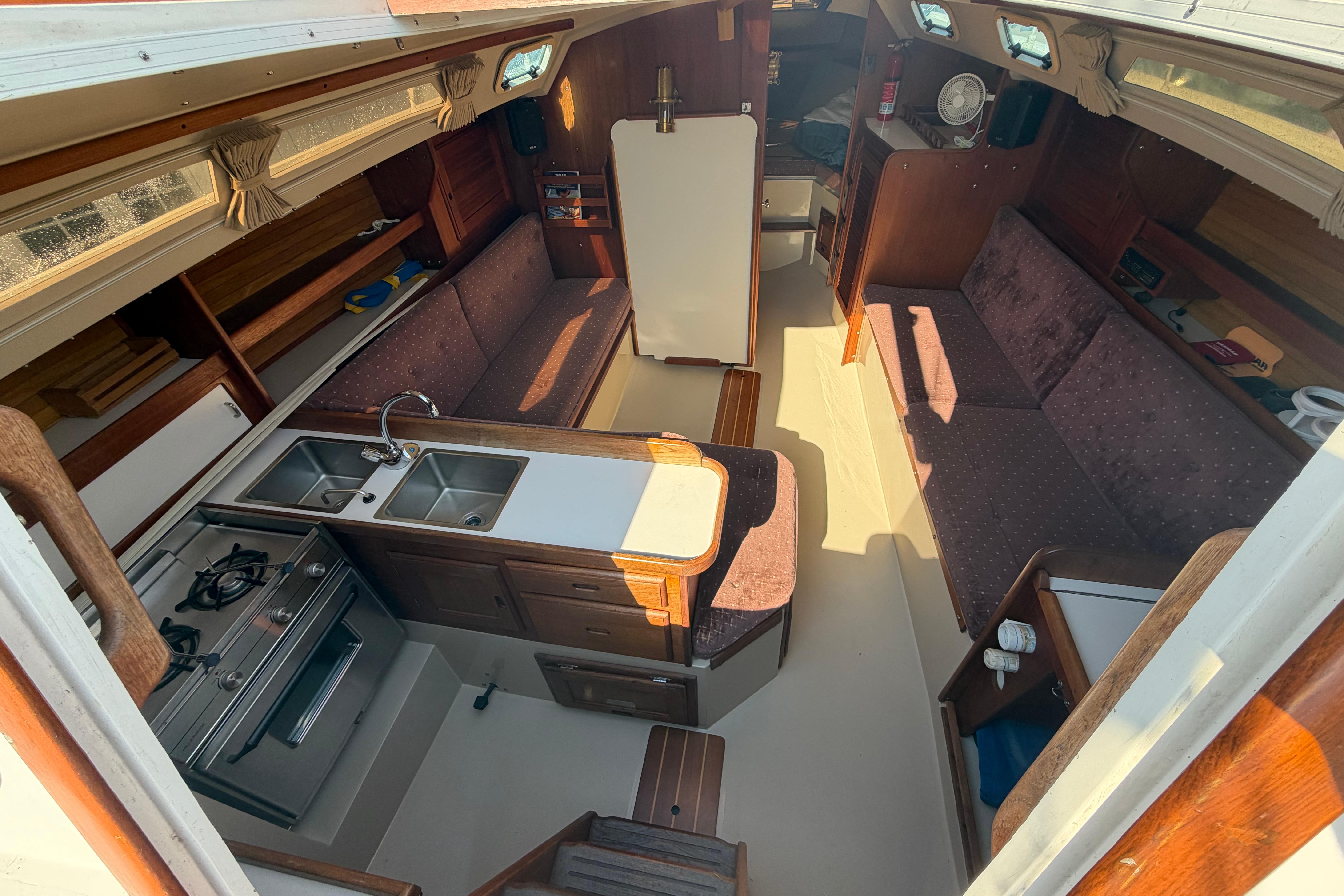 Interior of a 1988 Catalina 30 MkII sailboat with kitchen and seating area.