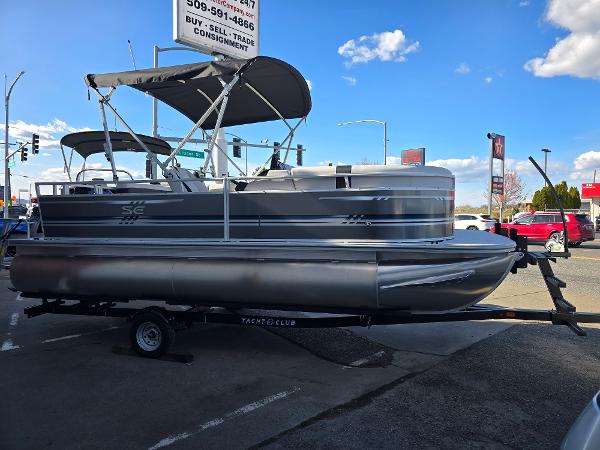 2025 Berkshire 20 CL pontoon boat on trailer, parked outdoors under a blue sky.