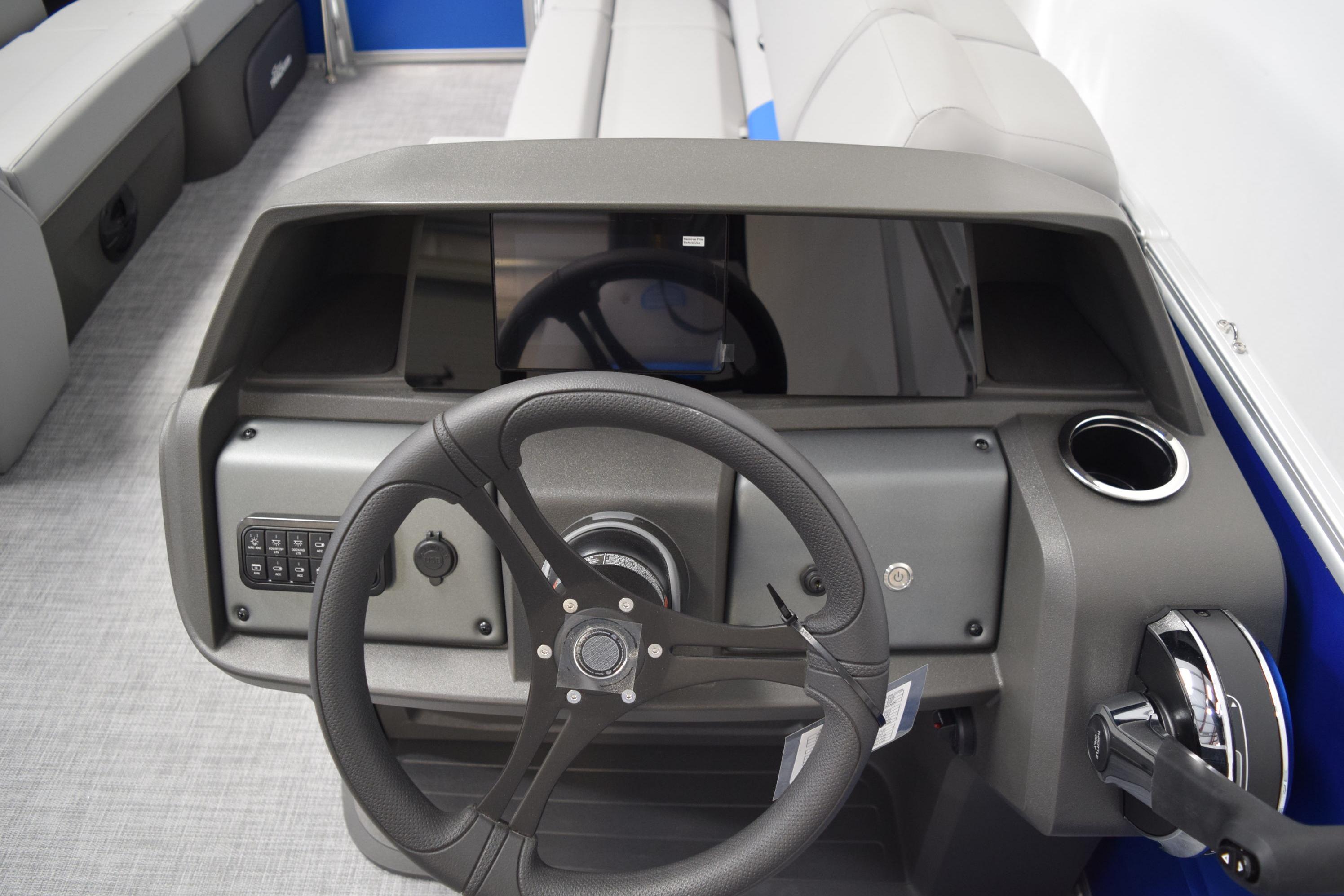 2026 Sun Tracker Party Barge 20 DLX steering console with modern controls and seating.