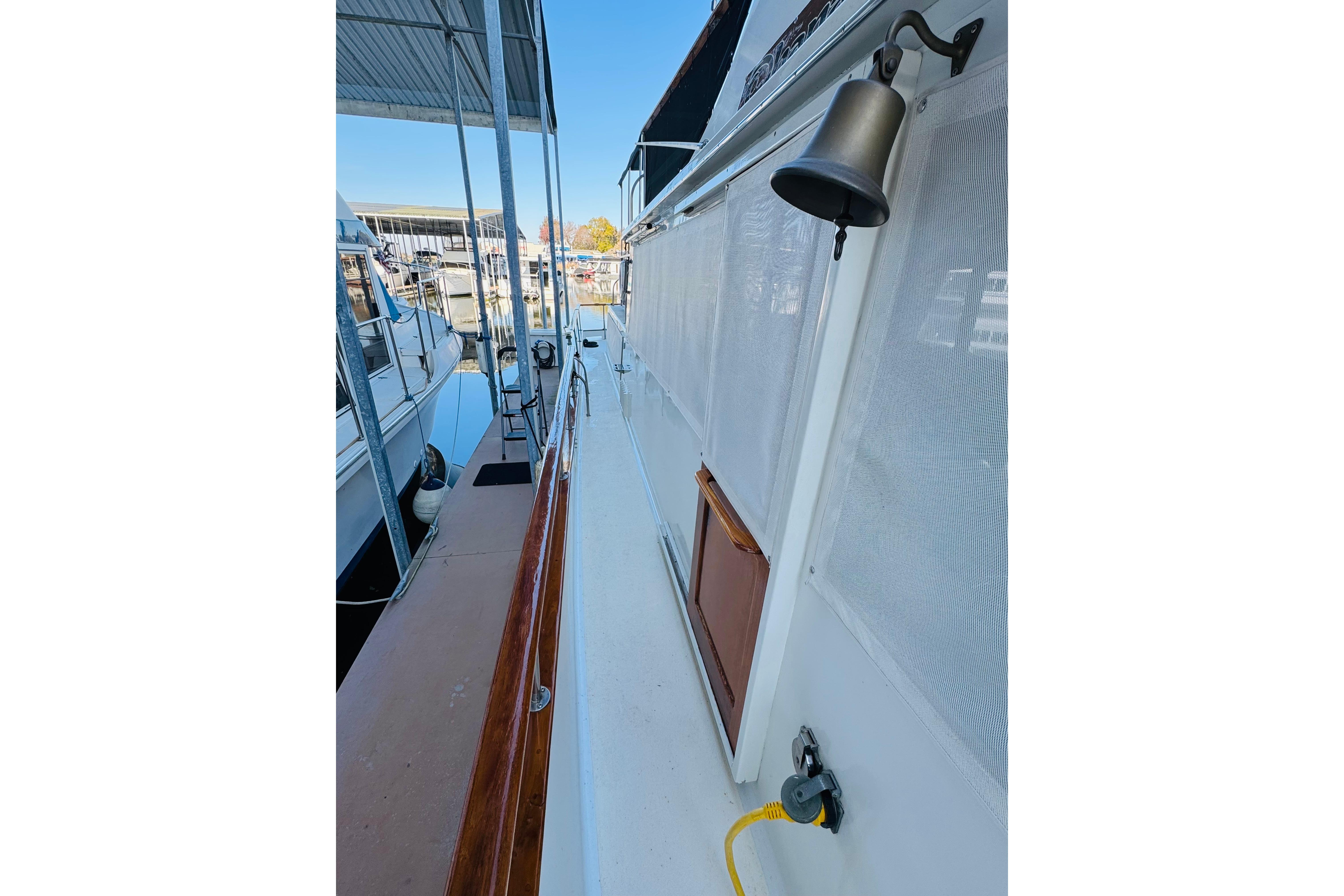 1978 Californian 42 LRC yacht docked, featuring a bell and wooden railings.