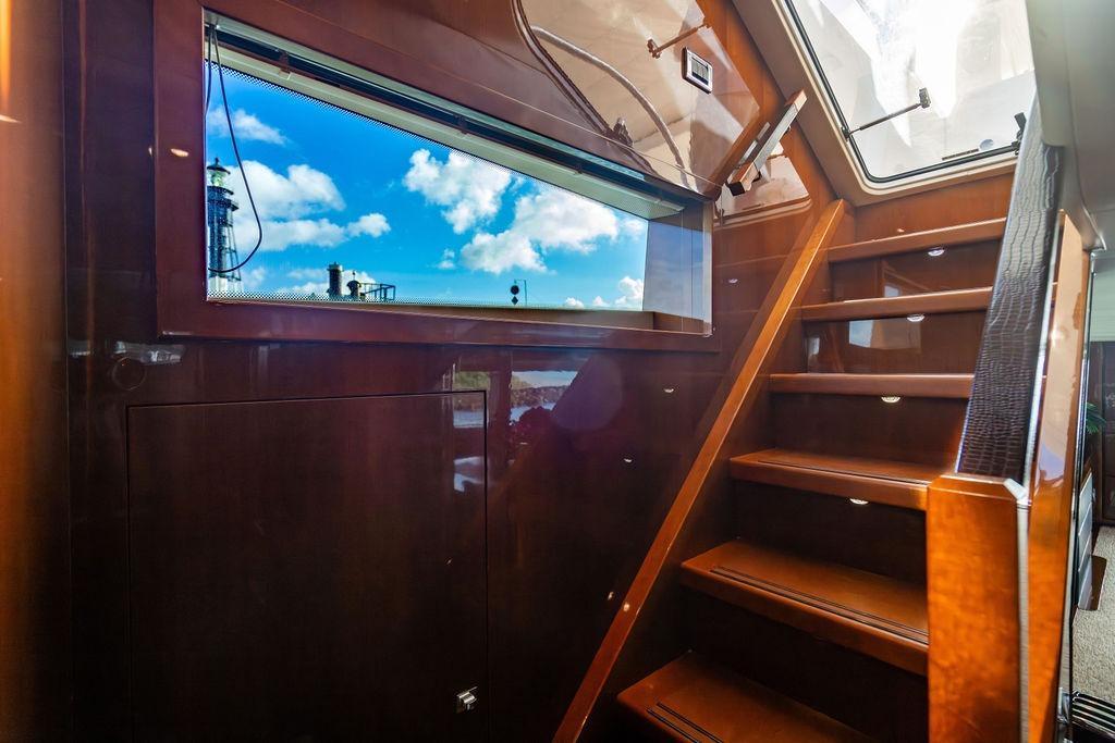 Interior staircase of 2010 Princess 95 Motor Yacht with window view.