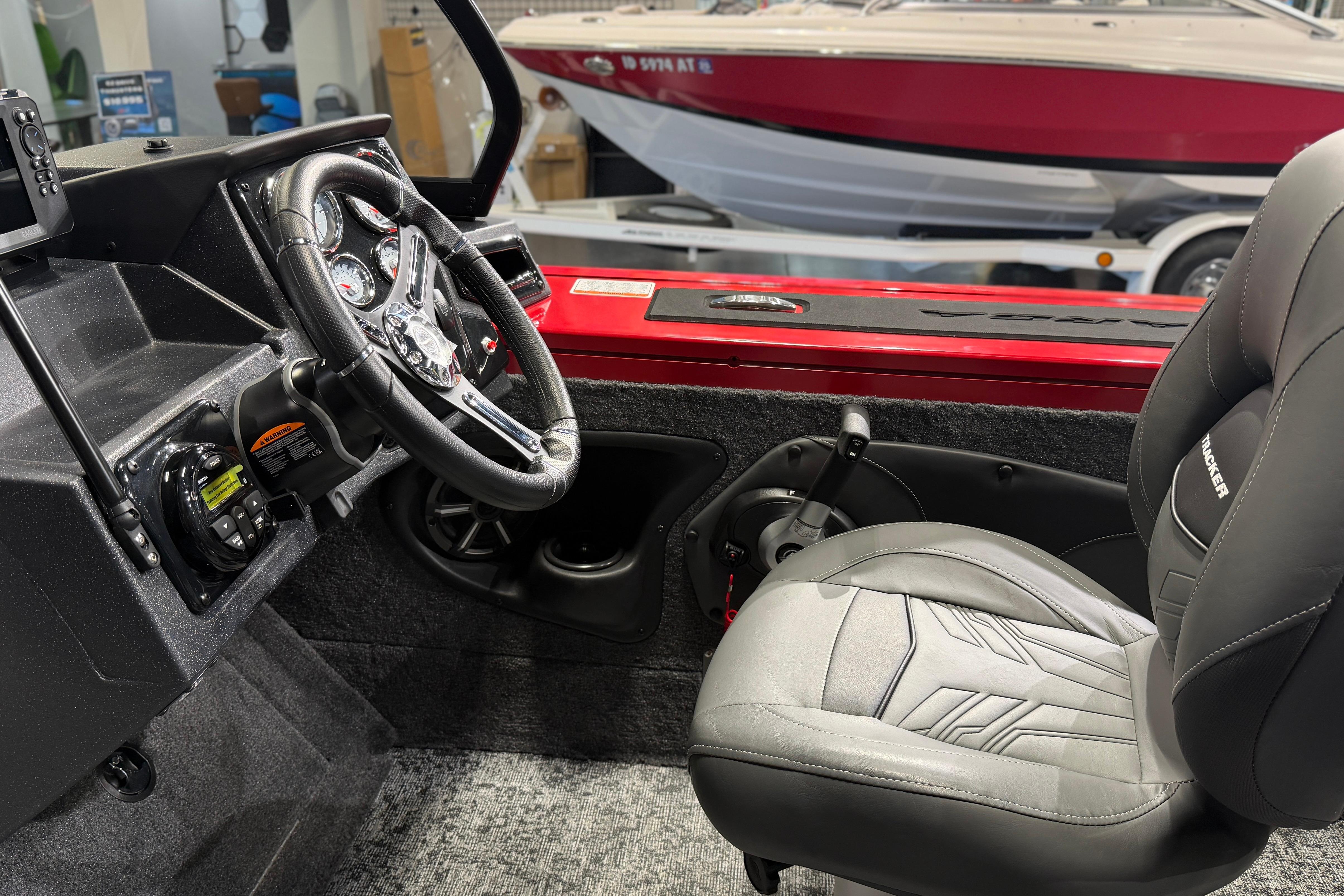 Interior of 2026 Tracker Targa V-18 Combo boat with steering wheel and seat.