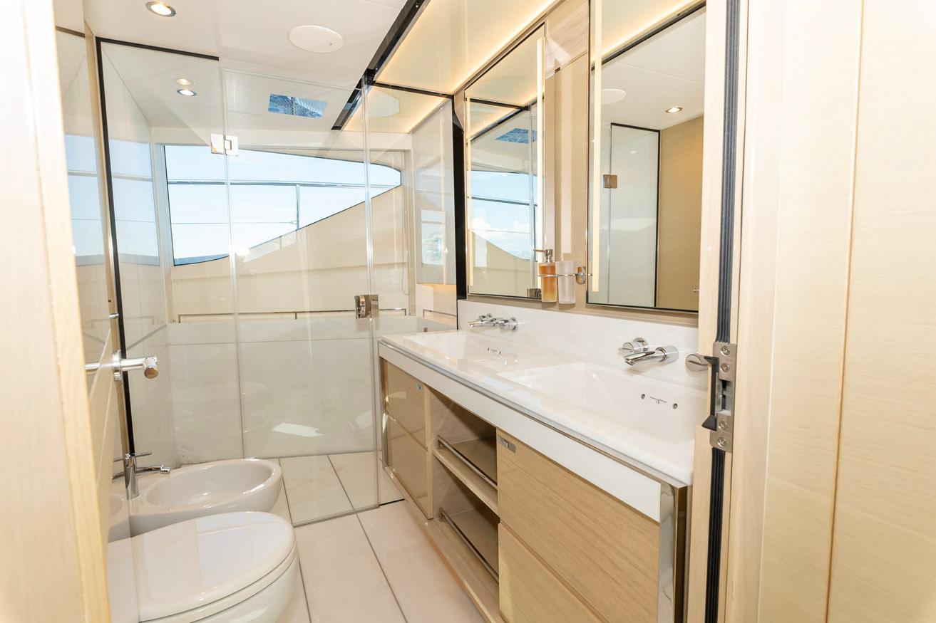 Luxurious bathroom interior on a 2019 Princess 30M yacht, featuring modern fixtures and ample lighting.