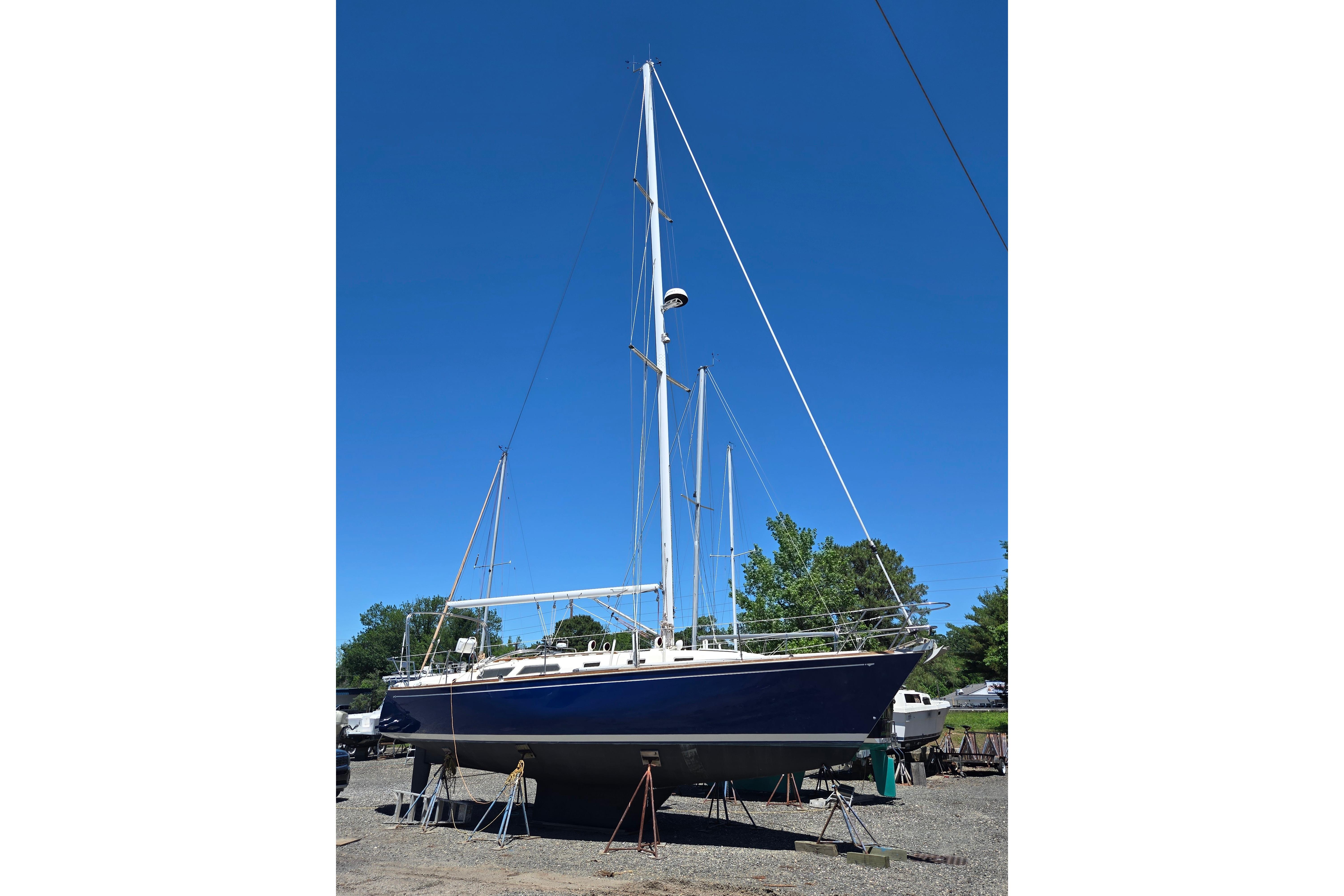 1988 Sabre 38 sailboat on stands under clear blue sky.