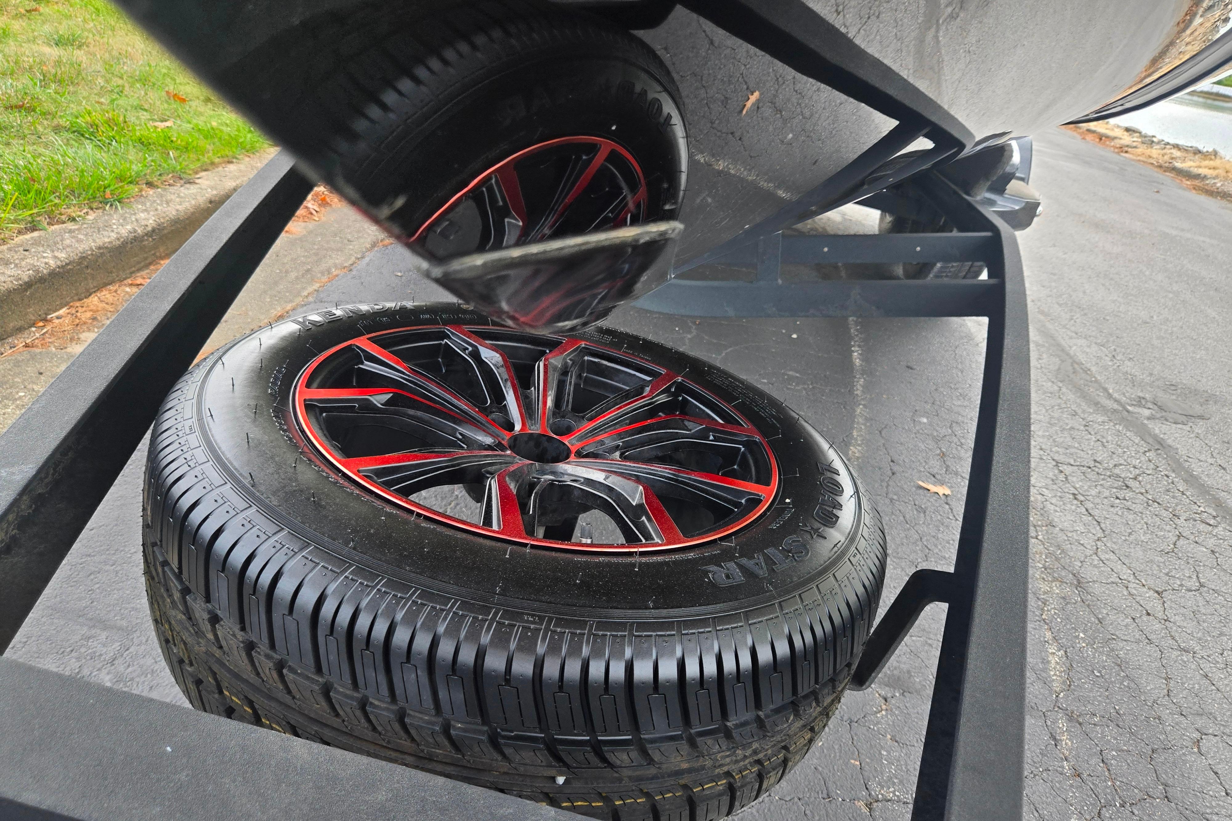 2022 Vexus VX20 trailer with stylish red and black wheel design.